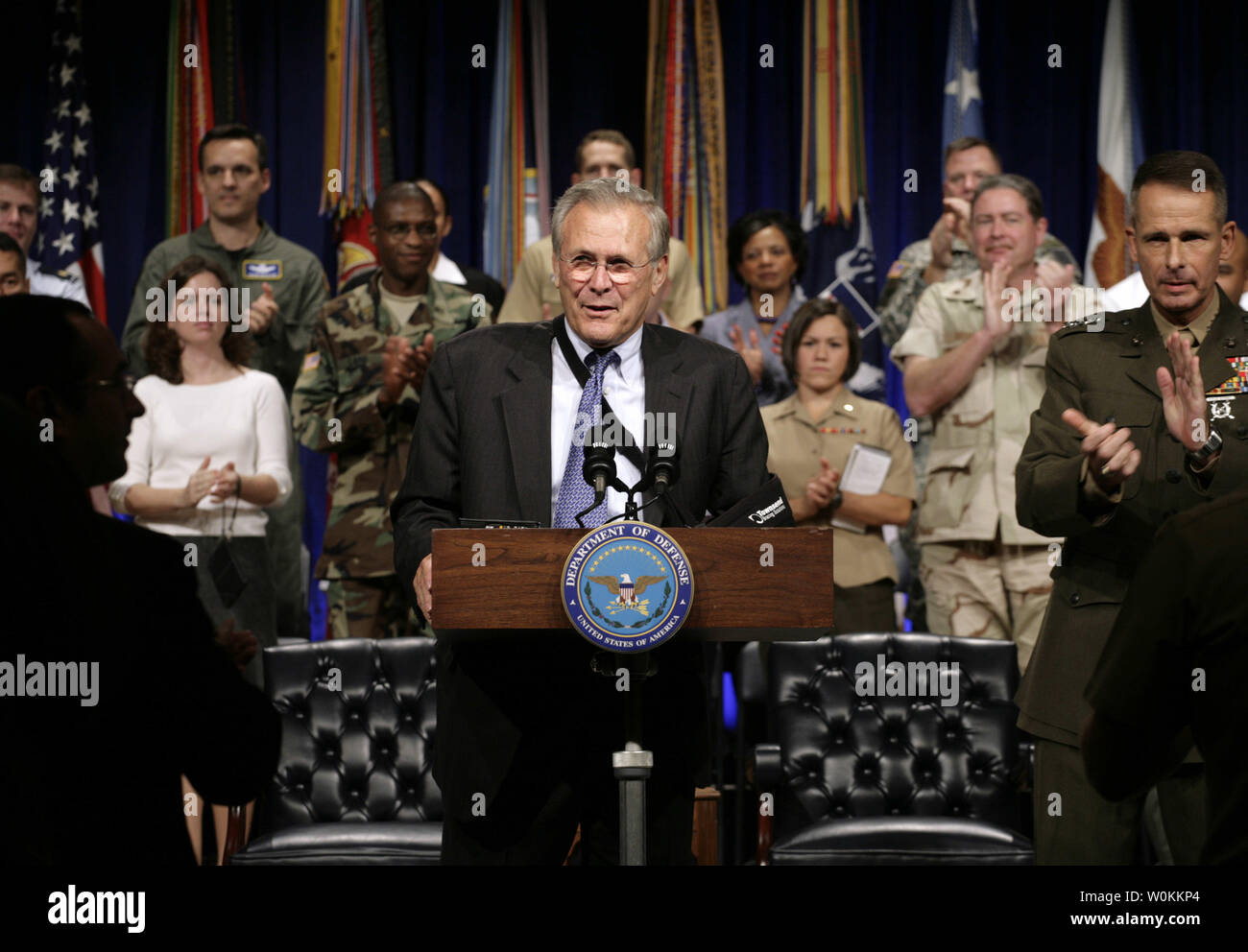 U.S. Defense Secretary Donald Rumsfeld (C) speaks as  General Peter Pace, Chairman of the Joint Chiefs of Staff, (R) applauds at the Pentagon Town Hall meeting in Washington, September 22, 2006.  (UPI Photo/Yuri Gripas) Stock Photo