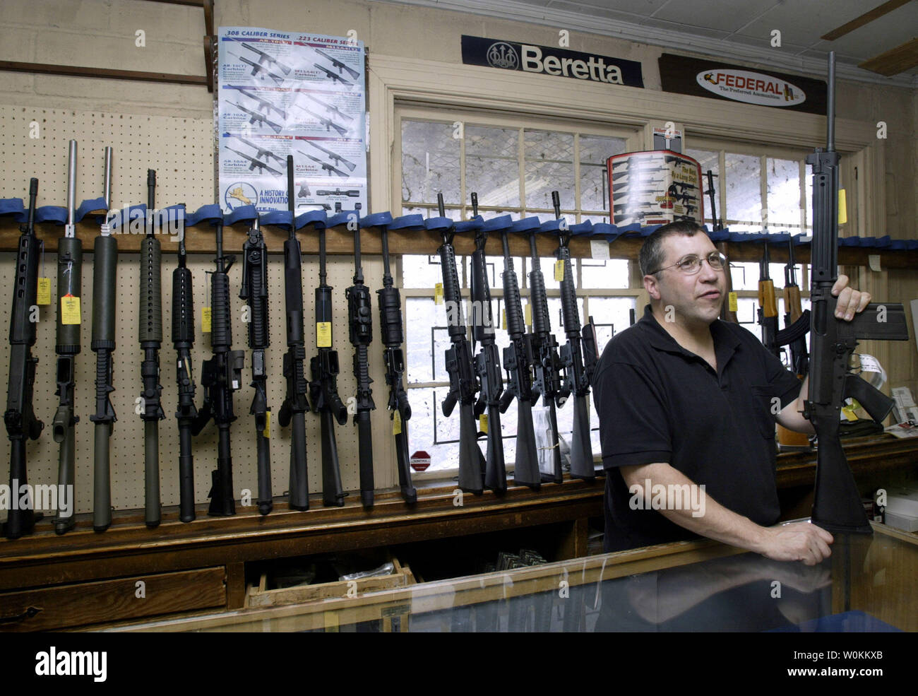 A salesman demonstrates the Cold Match target gun at the Potomac Arms gun store in Alexandria, Virginia in a September 10, 2004 file photo. In the aftermath of the deadly Virginia Tech University rampage, in which 33 people were shot by student Cho Seung-Hui, many are raising questions about lax gun controls in the United States. (UPI Photo/Yuri Gripas/Files) Stock Photo