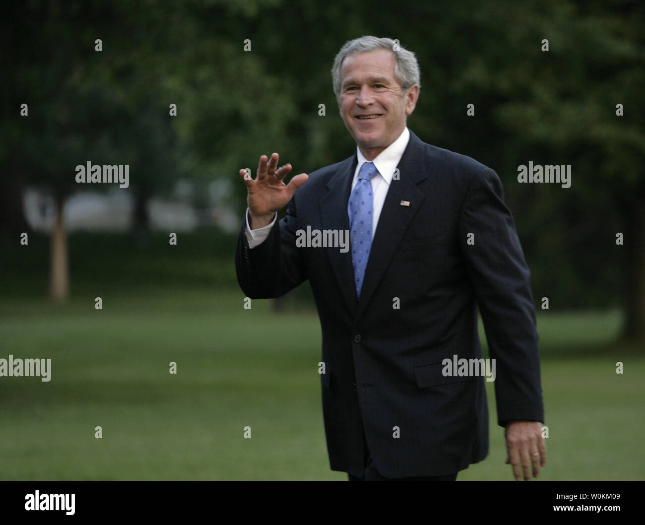 U.S. President George W. Bush waves as he walks on the South Lawn of ...