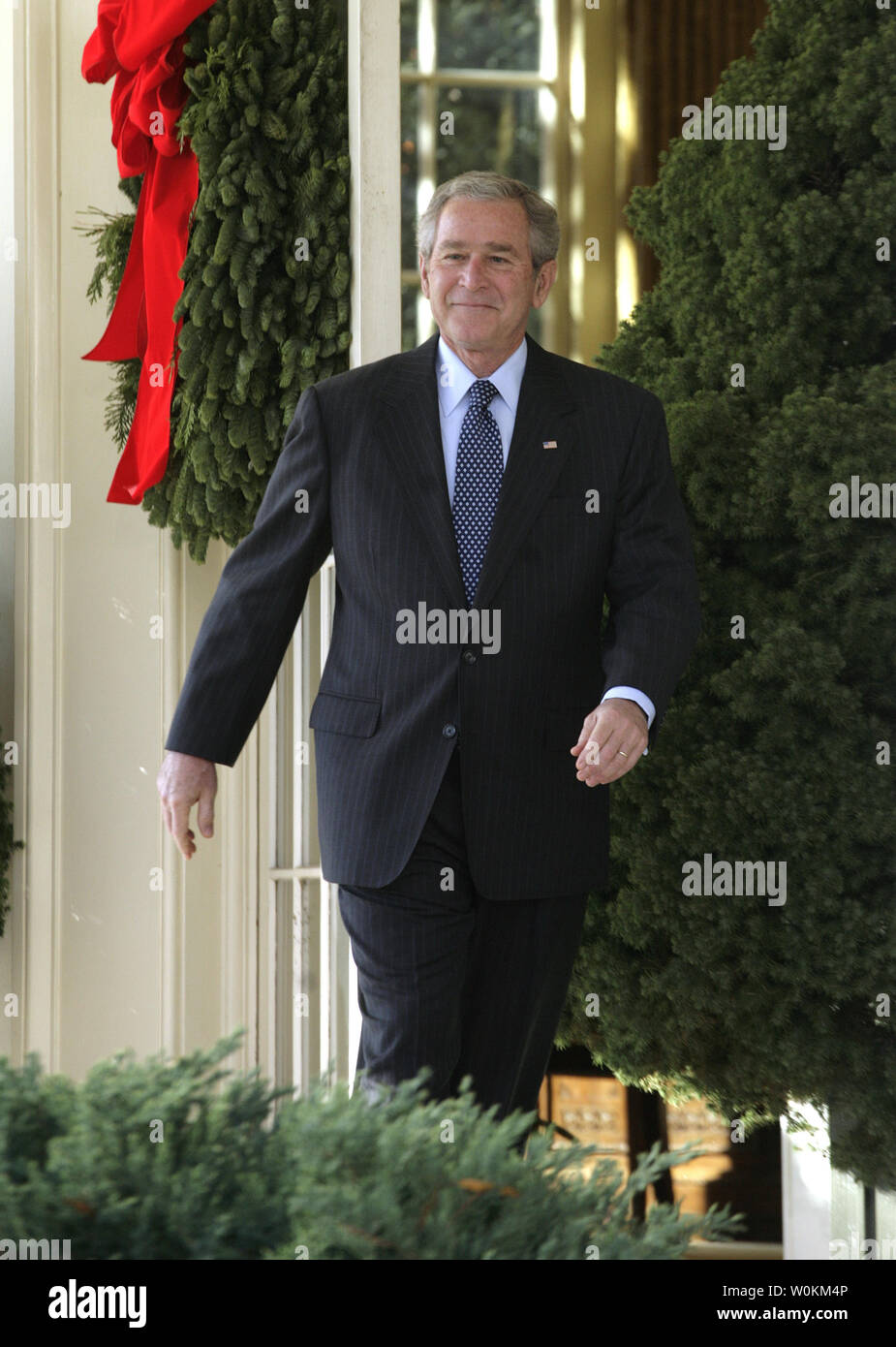 U.S. President George W. Bush walks from the Oval Office of  the White House to the Rose Garden to make a statement about Congress' legislative priorities for the remainder of the year in Washington on December 3, 2007. (UPI Photo/Yuri Gripas). Stock Photo