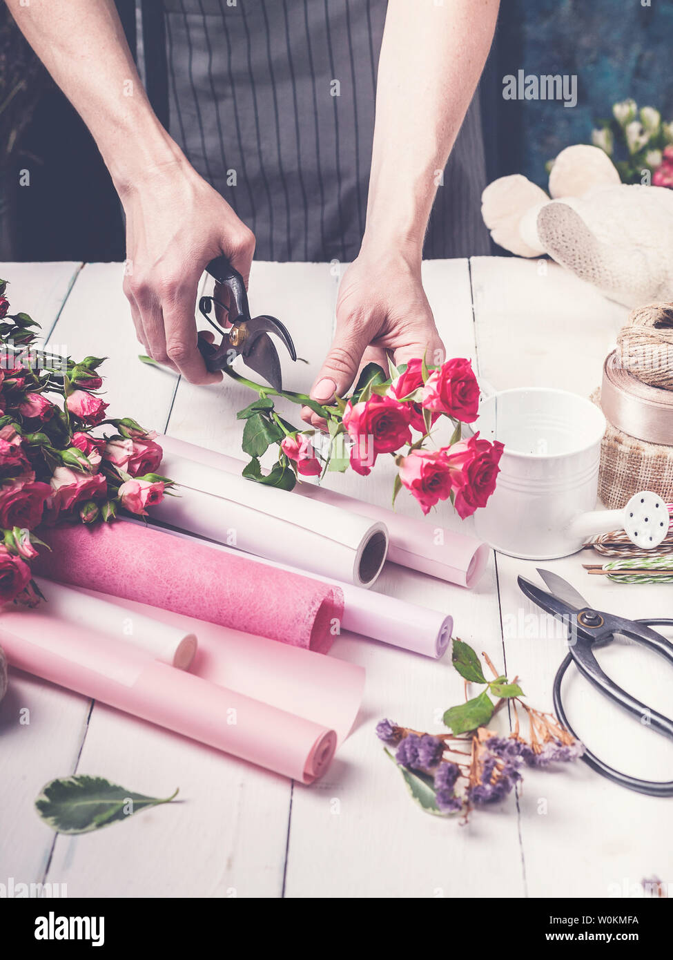 Florist at work. Female hands collect a wedding bouquet of roses. Small business concept Stock Photo
