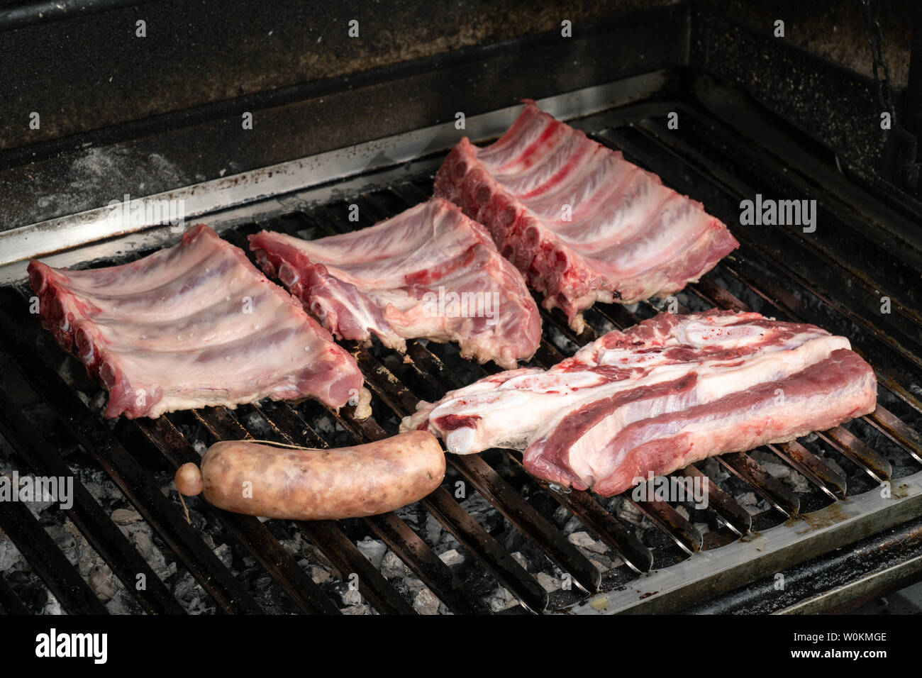 Barbecue with fresh pork ribs, beef and criollo sausage. Spanish churrasco Stock Photo
