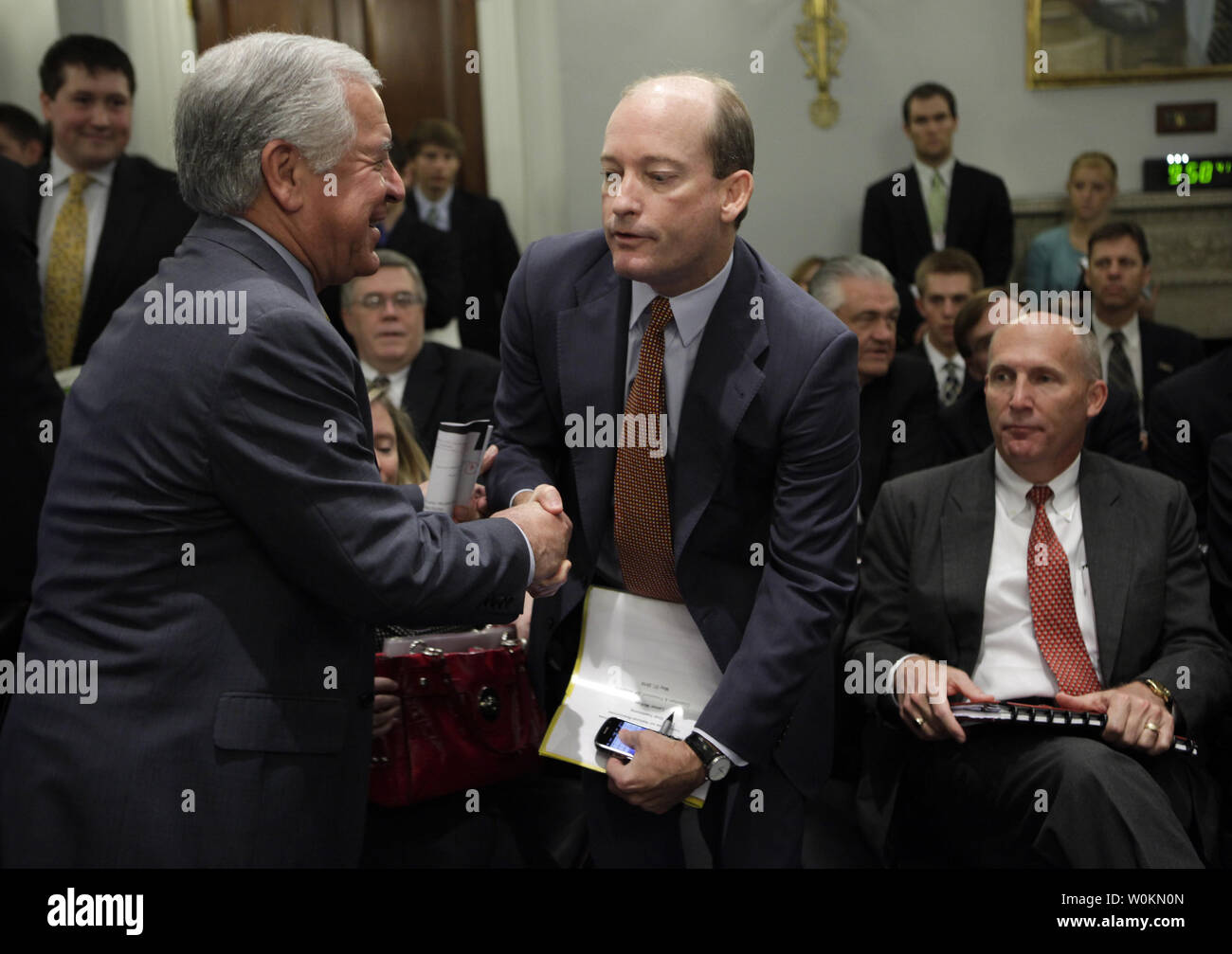 House Natural Resources Committee Chairman Nick J. Rahall (D-WV) (L) greets BP Chairman Lamar McKay (C) and Steve Newman, president and CEO of Transocean Ltd., before the committee hearing on Outer Continental Shelf Oil and Gas Strategy and Implications of the Deepwater Horizon Rig Explosion on Capitol Hill in Washington May 27, 2010.on April 28, 2010. UPI Photo/Yuri Gripas Stock Photo