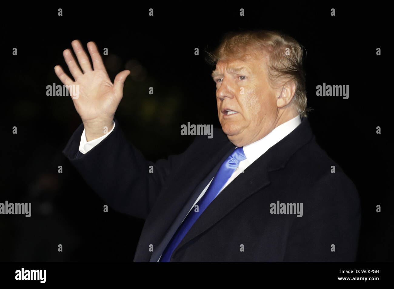 U.S. President Donald Trump waves as he walks on the South Lawn of the ...