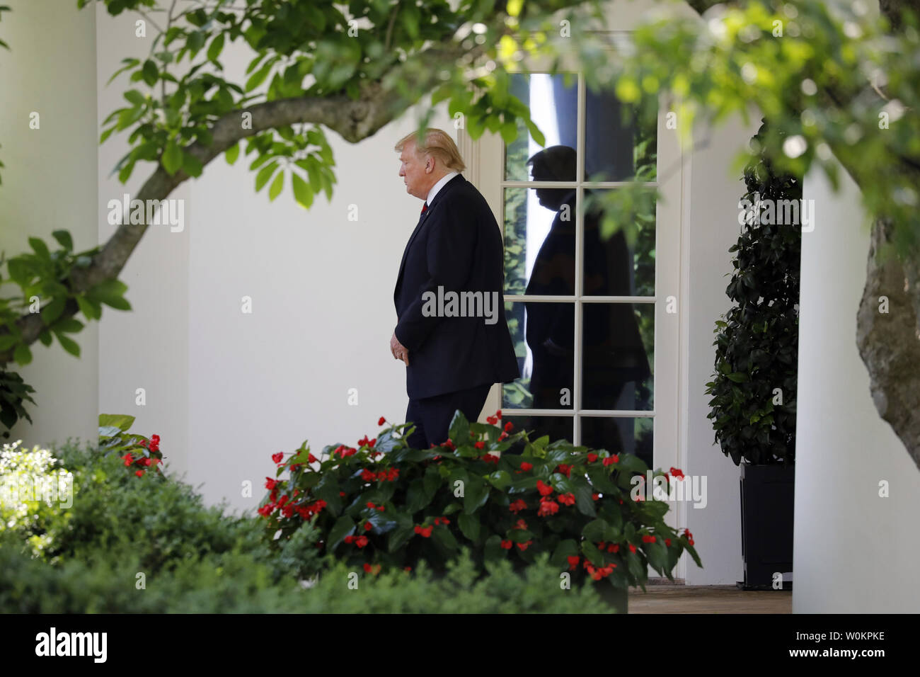 U.S. President Donald Trump walks out from the Oval Office of the White ...
