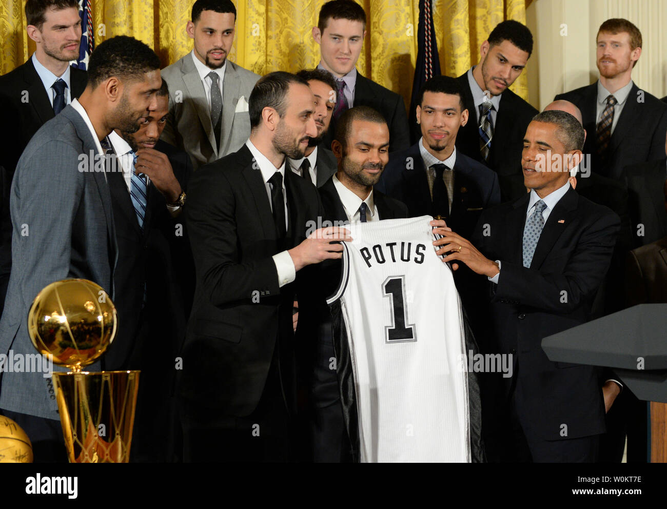 U.S. President Barack Obama receives a game jersey from San Antonio Spurs player Manu Ginobili (L) as Obama honors the 2014 NBA Champion Spurs in the East Room of the White House in Washington, DC. on January 12, 2015.  The Spurs won their fifth championship.   Photo by Pat Benic/UPI Stock Photo
