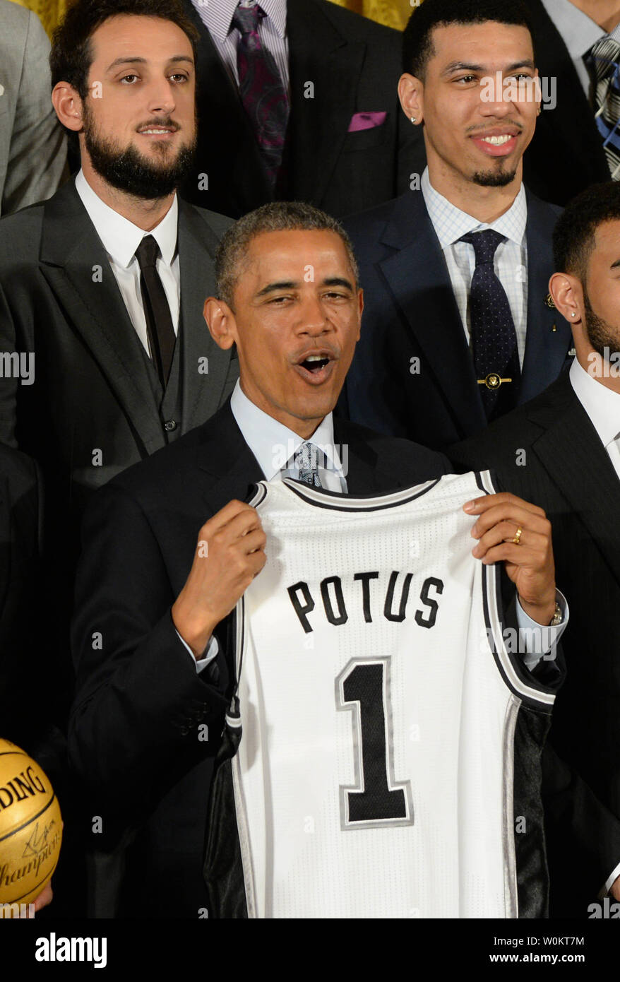 U.S. President Barack Obama receives a game jersey from San Antonio Spurs player Manu Ginobili (not shown) as Obama honors the 2014 NBA Champion Spurs in the East Room of the White House in Washington, DC. on January 12, 2015.  The Spurs won their fifth championship.   Photo by Pat Benic/UPI Stock Photo