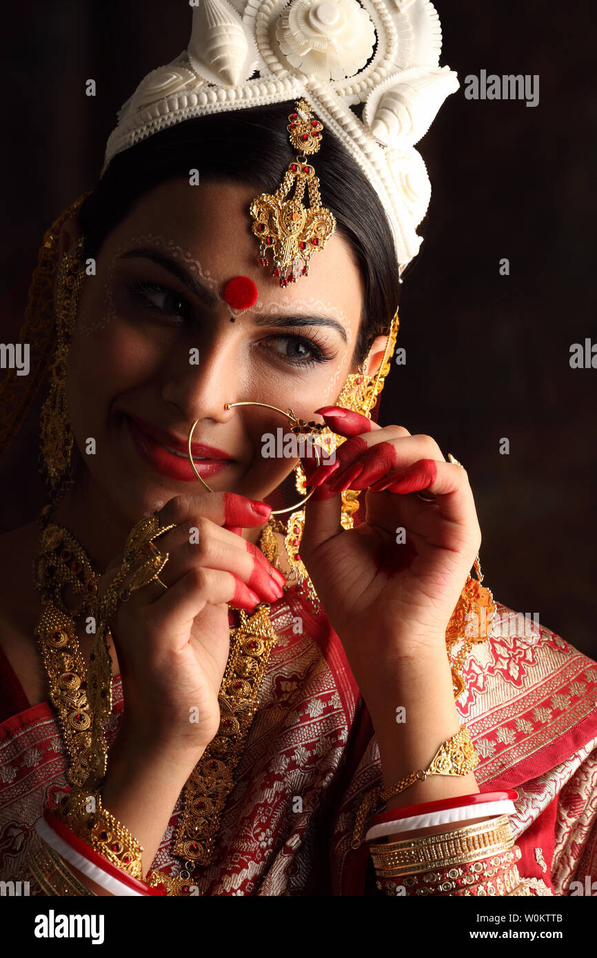 Bride Putting On a Traditional Nath Nose Ring · Free Stock Photo