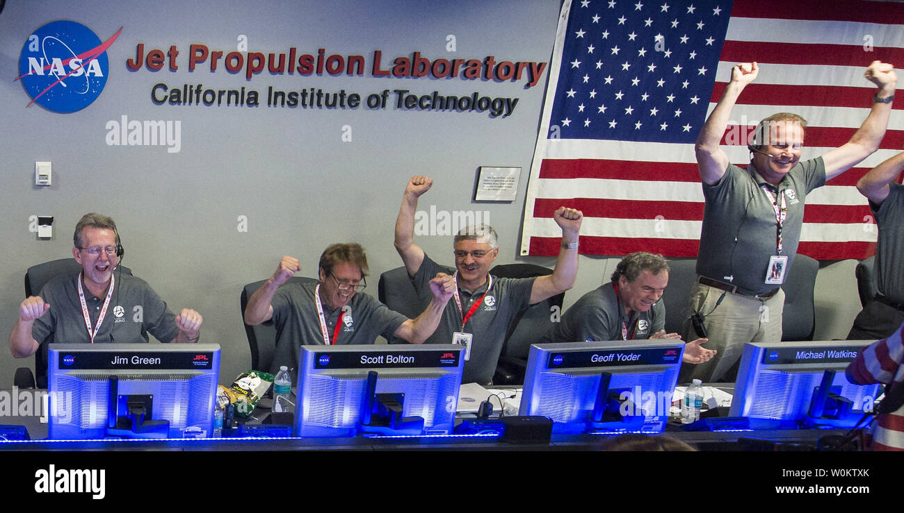 Juno team scientists celebrate after they received confirmation from the Juno spacecraft that it had successfully completed the engine burn and entered orbit of Jupiter, Monday, July 4, 2016 in mission control of the Space Flight Operations Facility at the Jet Propulsion Laboratory in Pasadena, California. The Juno mission launched August 5, 2011 and will orbit the planet for 20 months. From left to right: Dr. Jim Green, Planetary Science Division Director, NASA; Scott Bolton, Juno principal investigator, Southwest Research Institute; Geoff Yoder, acting Associate Administrator for the Science Stock Photo