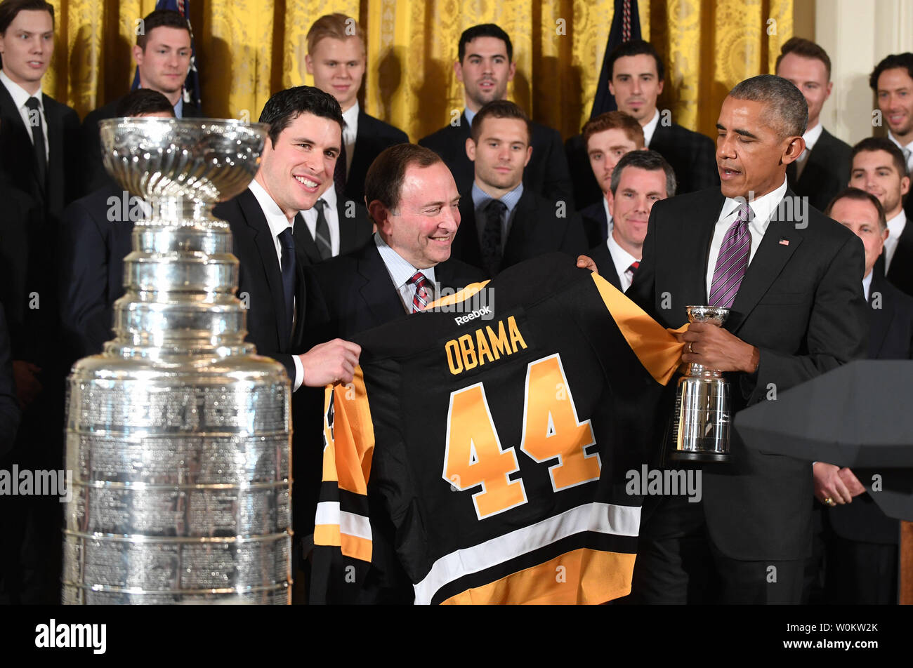 President Barack Obama receives a jersey from the Pittsburgh Penguins  during a ceremony to honor them for their 2009 Stanley Cup championship  victory on September 10, 2009 in Washington, DC, USA on