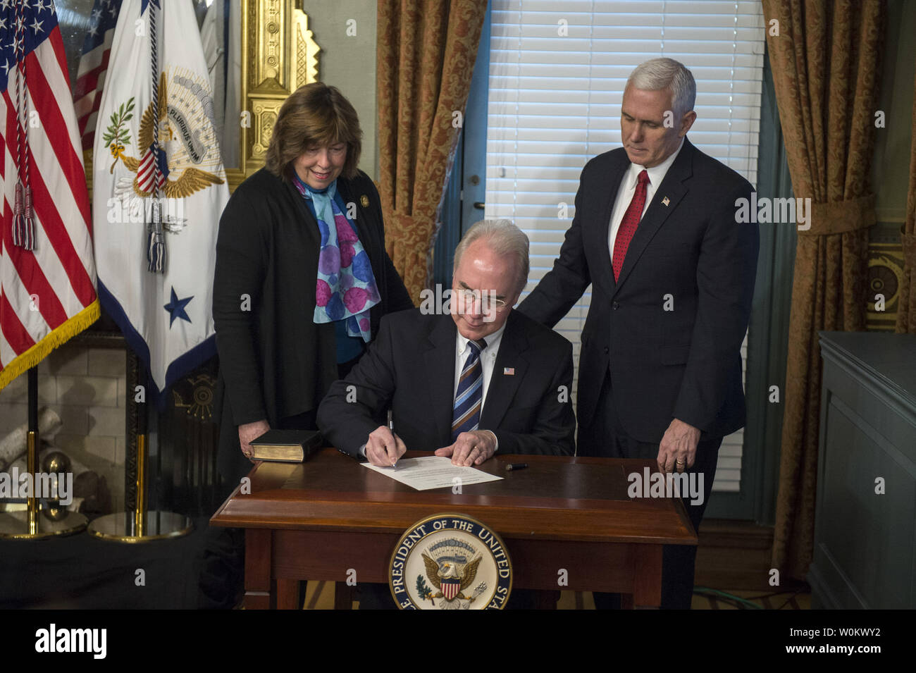 Tom Price signs the official forms after being sworn in by Vice President  Mike Pence as the Heath and Human Services Secretary in the Vice  President's Ceremonial Office in the EEOB next