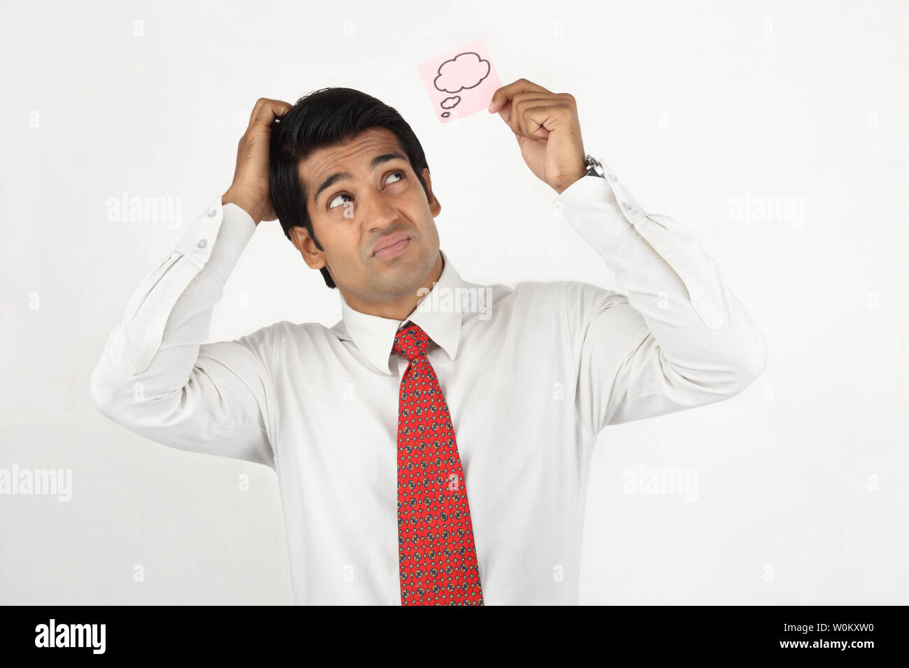 Businessman holding a blank thought bubble on adhesive note Stock Photo