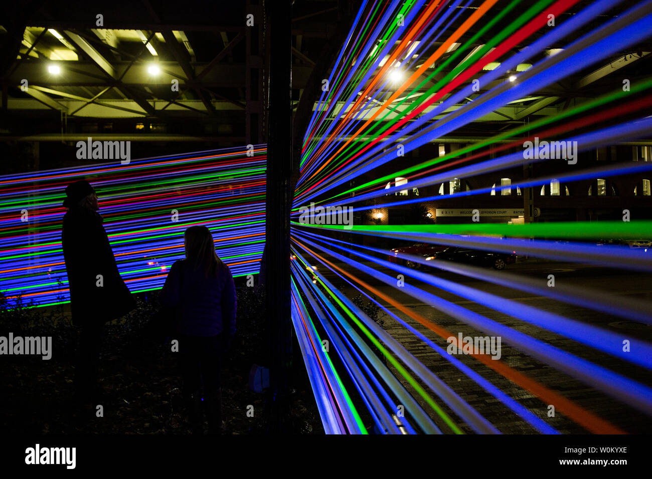 People view 'Horizontal Interface' an installation made up of stretched UV tape which is part of Georgetown GLOW in Georgetown in Washington, DC on December 9, 2017. GLOW is an annual outdoor public light exhibit put together by the Georgetown Business Improvement District.     Photo by Erin Schaff/UPI Stock Photo