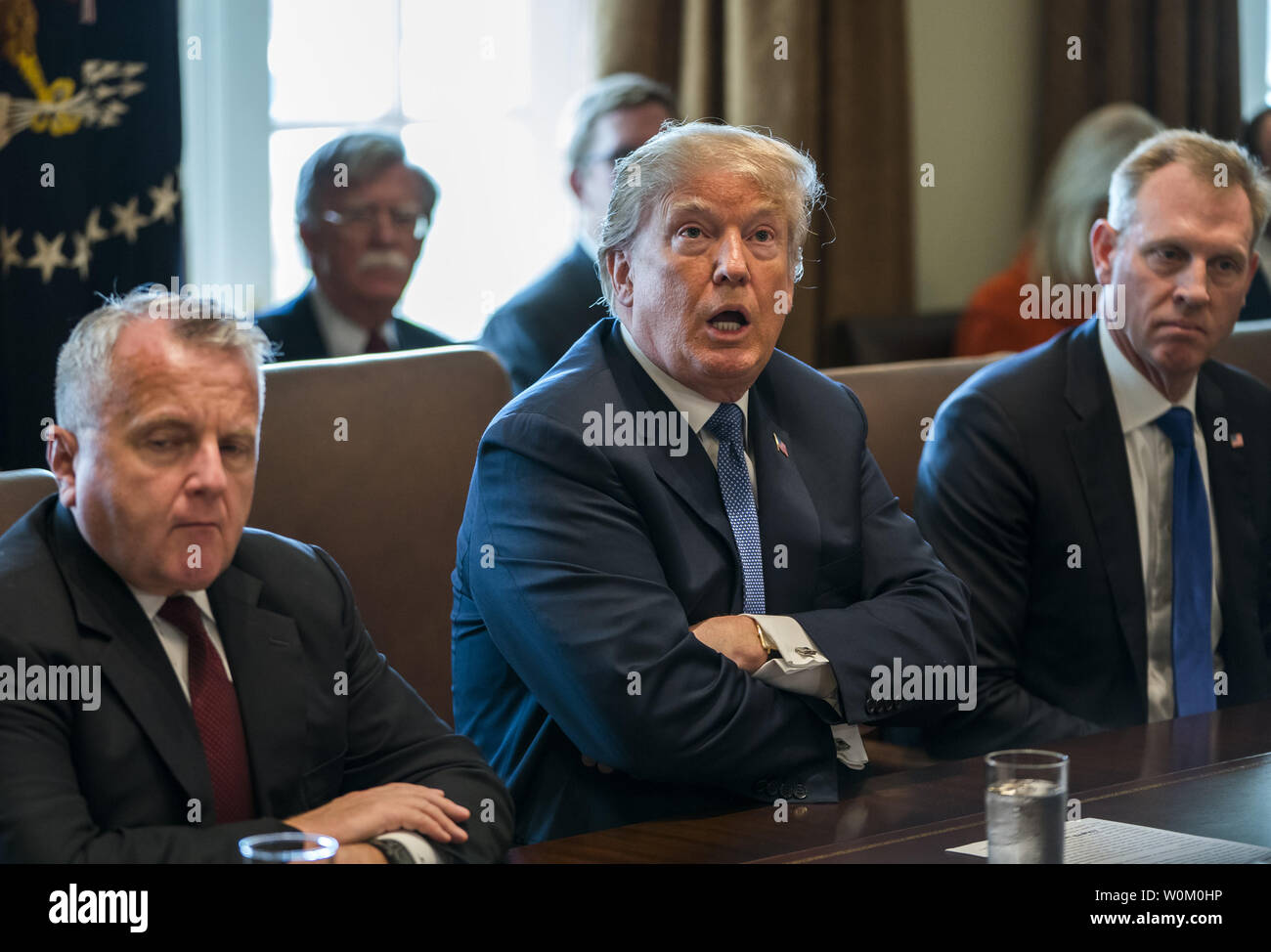 President Donald J. Trump (C) speaks with the media before a meeting with his cabinet in the Cabinet Room of the White House in Washington DC on April 9, 2018. Trump said he will decide in the next few days whether  the US will respond militarily for the reported chemical weapons attack in Syria.  Photo by Jim Lo Scalzo/UPI Stock Photo
