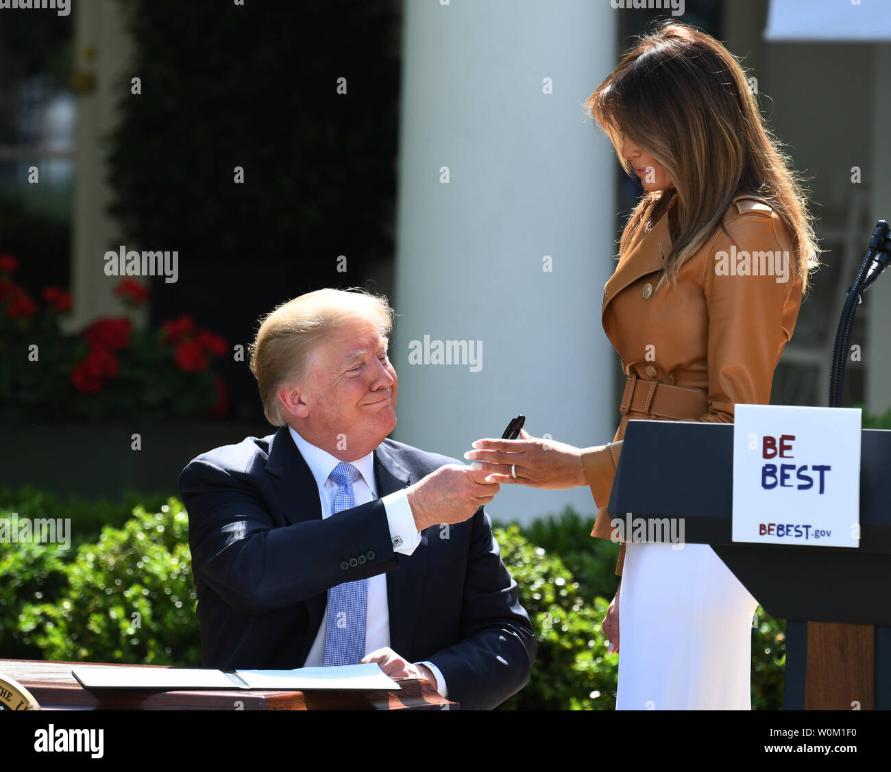 First Lady Melania Trump smiles as she receives a pen by  U.S. President Donald Trump after he signed a  proclamation for 'National Be Best Day' after Melania announced her 'Be Best' initiative in the Rose Garden of the White House in Washington, DC on May 7, 2018.  The 'Be Best' program will focus on fighting opioid abuse, positivity on social media, and well-being.       Photo by Pat Benic/UPI Stock Photo