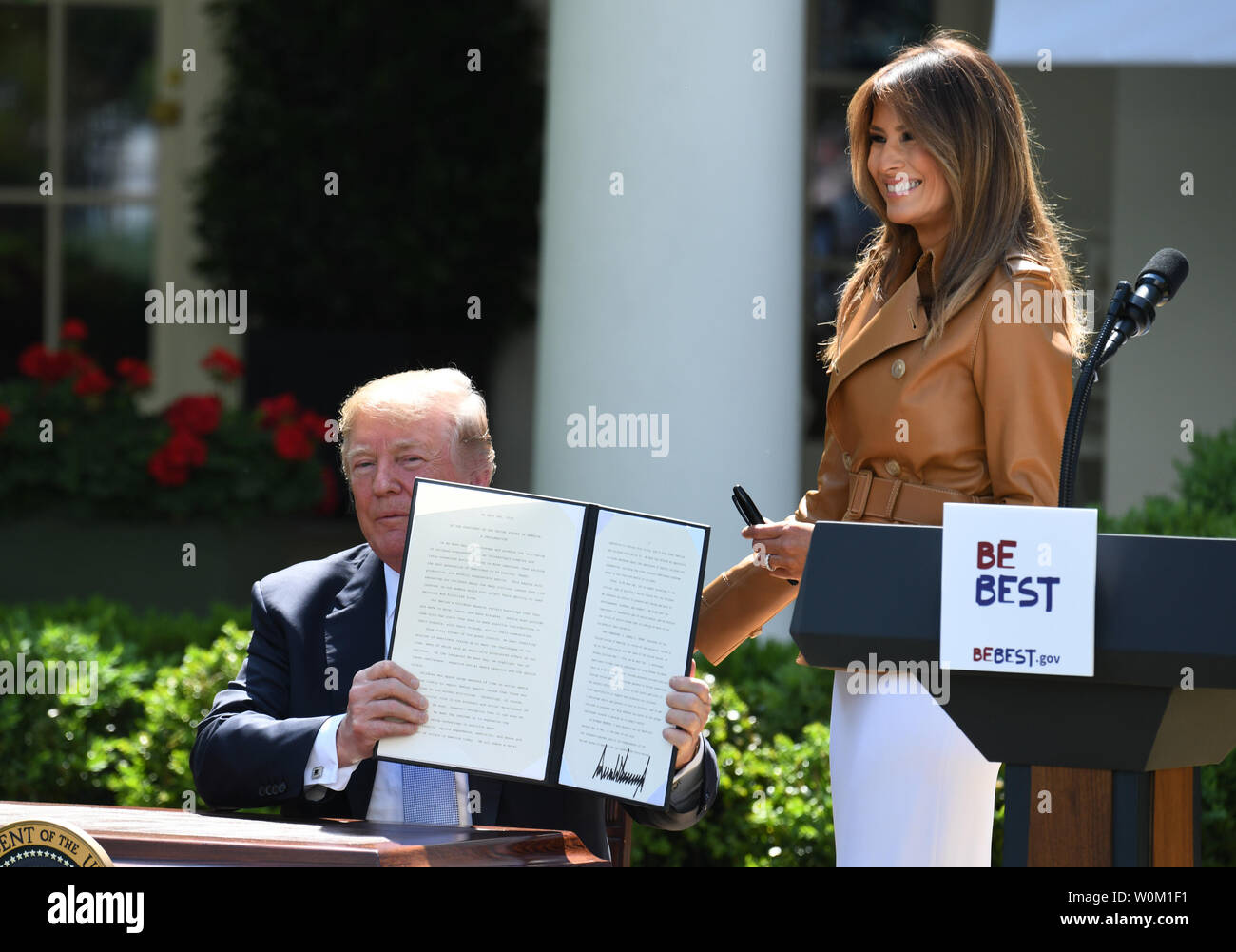 First Lady Melania Trump smiles as U.S. President Donald Trump holds up his proclamation for 'National Be Best Day' after Melania announced her 'Be Best' initiative in the Rose Garden of the White House in Washington, DC on May 7, 2018.  The 'Be Best' program will focus on fighting opioid abuse, positivity on social media, and well-being.       Photo by Pat Benic/UPI Stock Photo