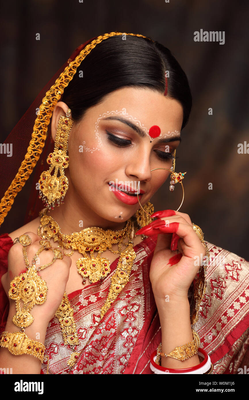 Image of Close Up Portrait Of Very Beautiful Young Indian Bride In  Luxurious Bridal Costume With Makeup And Heavy Jewellery In Studio Lighting  Indoor. Wedding Fashion.-YO884748-Picxy