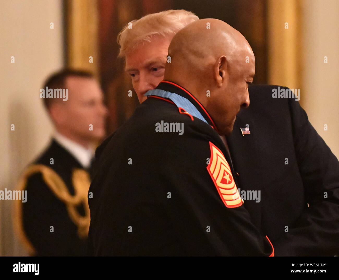 President Donald Trump wispers to Medal of Honor  recipient retired Sgt. Maj. John Canley fafter the award in the East Room of the White House in Washington, DC on October 17, 2018. The 80-year-old former Marine who lives in Oxnard, California, received the award for service in the battle of Hue 50 years ago.   Photo by Pat Benic/UPI Stock Photo