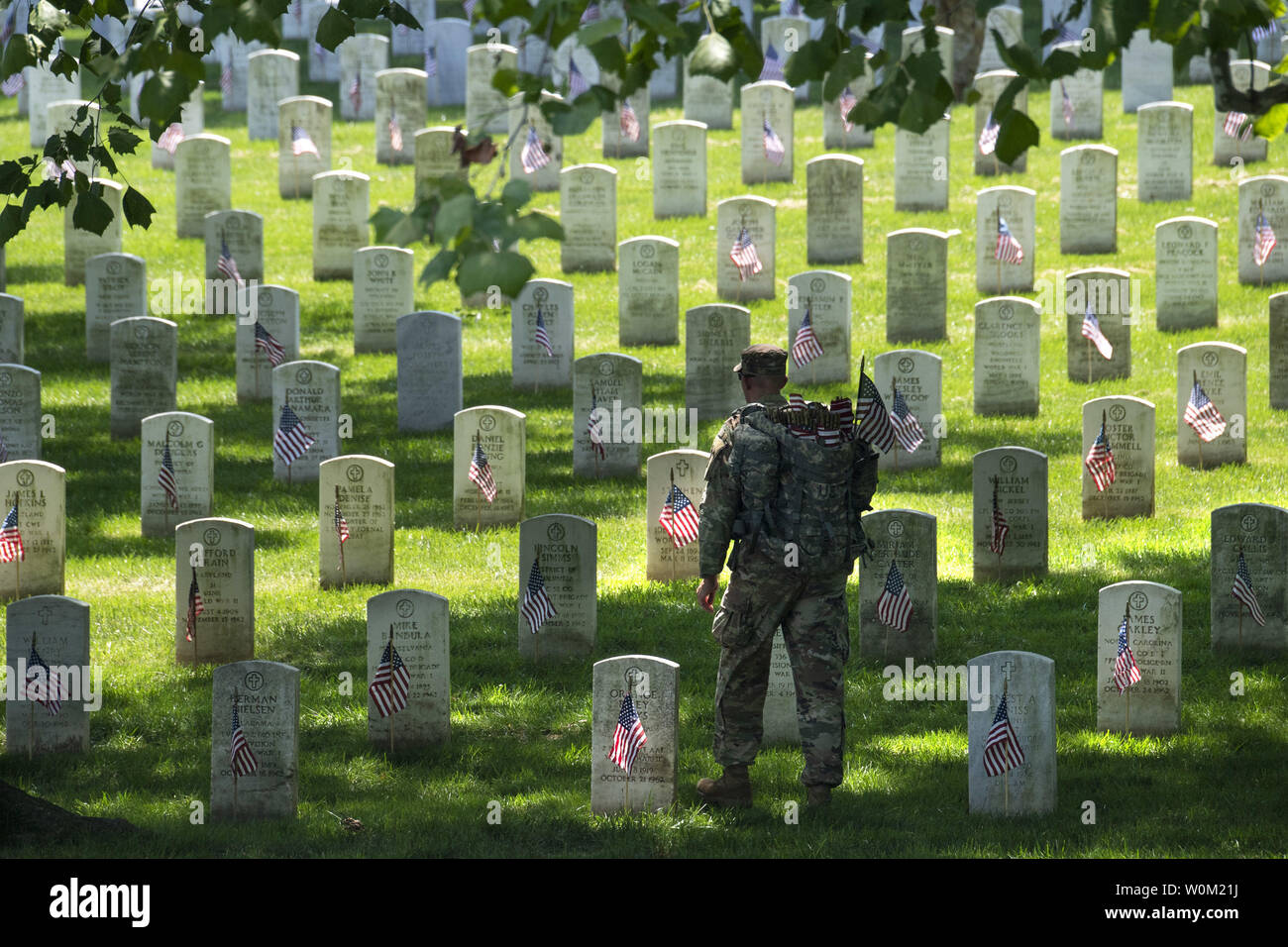 Old Guard U.S. Army soldiers place American flags at the tombstones of the fallen at Arlington National Cemetery in Arlington, Virginia on Mary 23, 2019.  More than 250,000 flags are place on the tombsites  prior to Memorial Day.   Photo by Pat Benic/UPI Stock Photo
