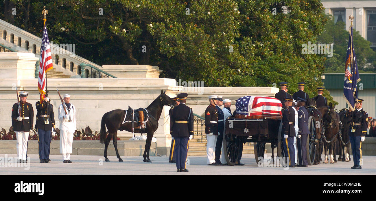 A riderless horse with a pair of boots placed backwards through the
