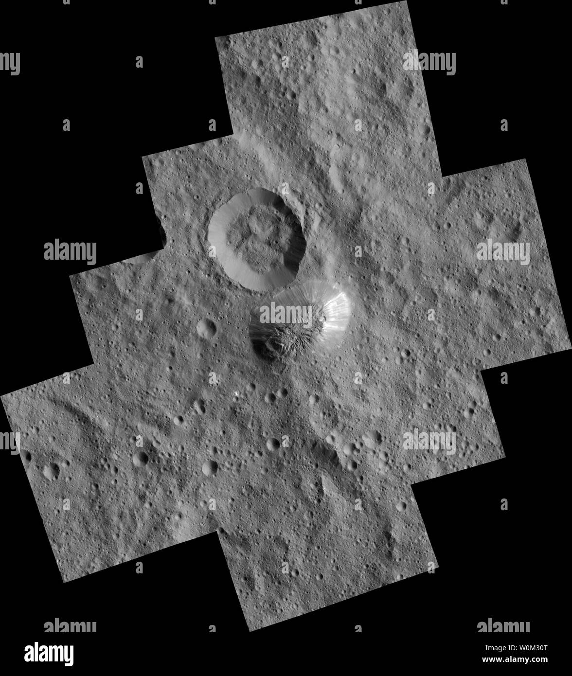 The mysterious mountain Ahuna Mons is seen in this mosaic of images from NASA's Dawn spacecraft. Dawn took these images from its low-altitude mapping orbit in December 2015. The resolution of the component images is 120 feet (35 meters) per pixel. On its steepest side, this mountain is about 3 miles (5 kilometers) high, with a diameter of about 12 miles (20 kilometers). On March 6, 2015, NASA's Dawn spacecraft slid gently into orbit around Ceres, the largest body in the asteroid belt between Mars and Jupiter. UPI Stock Photo
