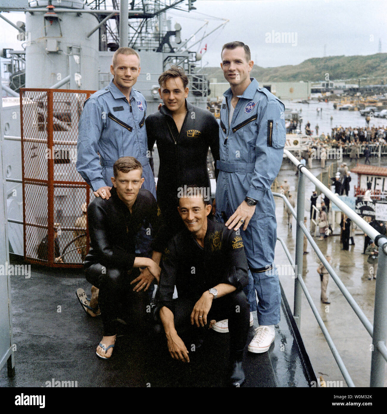 The Gemini 8 crew stands on the deck of the recovery vessel, the USS Leonard F. Mason, with three U.S. Air Force Pararescuemen, on March 17, 1966. From left to right (standing) are astronaut Neil Armstrong, command pilot; A2C Glenn Moore; astronaut David Scott, pilot; kneeling, left to right are A1C Eldridge Neal; and SSG Larry Huyett. March 16, 2016 marks the 50th anniversary of NASA's Gemini 8 mission, the sixth manned spaceflight conducted during the United States' Project Gemini program. The primary objective of the mission, the successful docking of two spacecraft in orbit, a first in spa Stock Photo