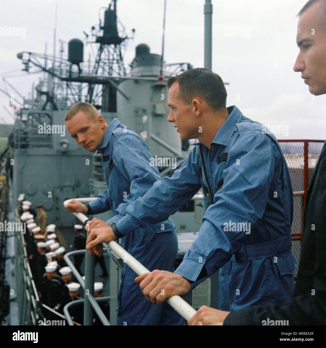 NASA astronauts Neil Armstrong (left), Gemini 8 command pilot, and David Scott (right), pilot, stand on the deck of the USS Leonard F. Mason upon its arrival at Naha, Okinawa, on March 17, 1966. March 16, 2016 marks the 50th anniversary of NASA's Gemini 8 mission, the sixth manned spaceflight conducted during the United States' Project Gemini program. The primary objective of the mission, the successful docking of two spacecraft in orbit, a first in spaceflight, was a success though the crew would experience a critical in-space system failure, forcing them to abandon the mission prematurely. U Stock Photo