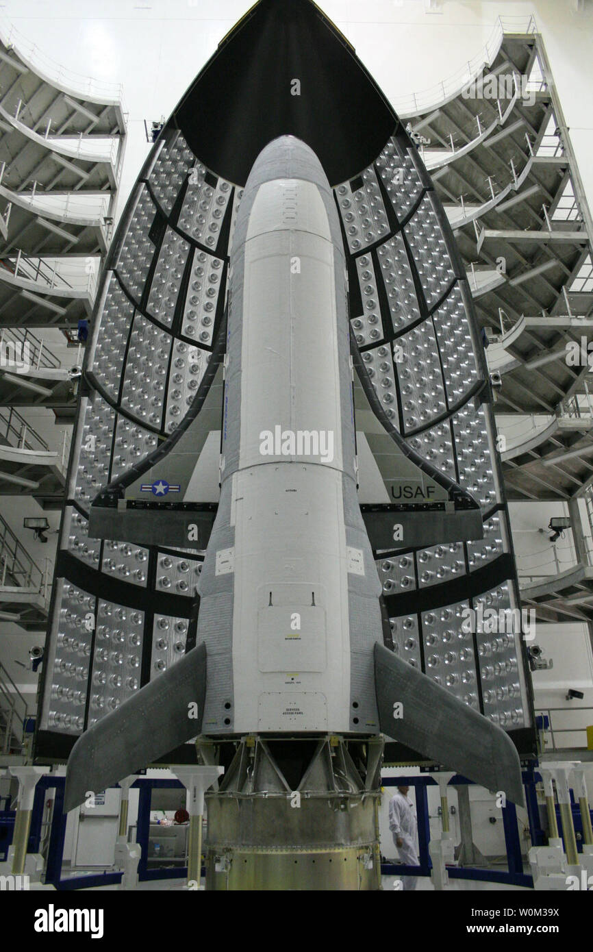 The X-37B Orbital Test Vehicle (OTV), the Air Force's unmanned, reusable space plane, waits in the encapsulation cell of the Evolved Expendable Launch vehicle on April 5, 2010, at the Astrotech facility in Titusville, Fla. Half of the Atlas V five-meter fairing is visible in the background. Photo by Boeing/U.S. Air Force/UPI Stock Photo