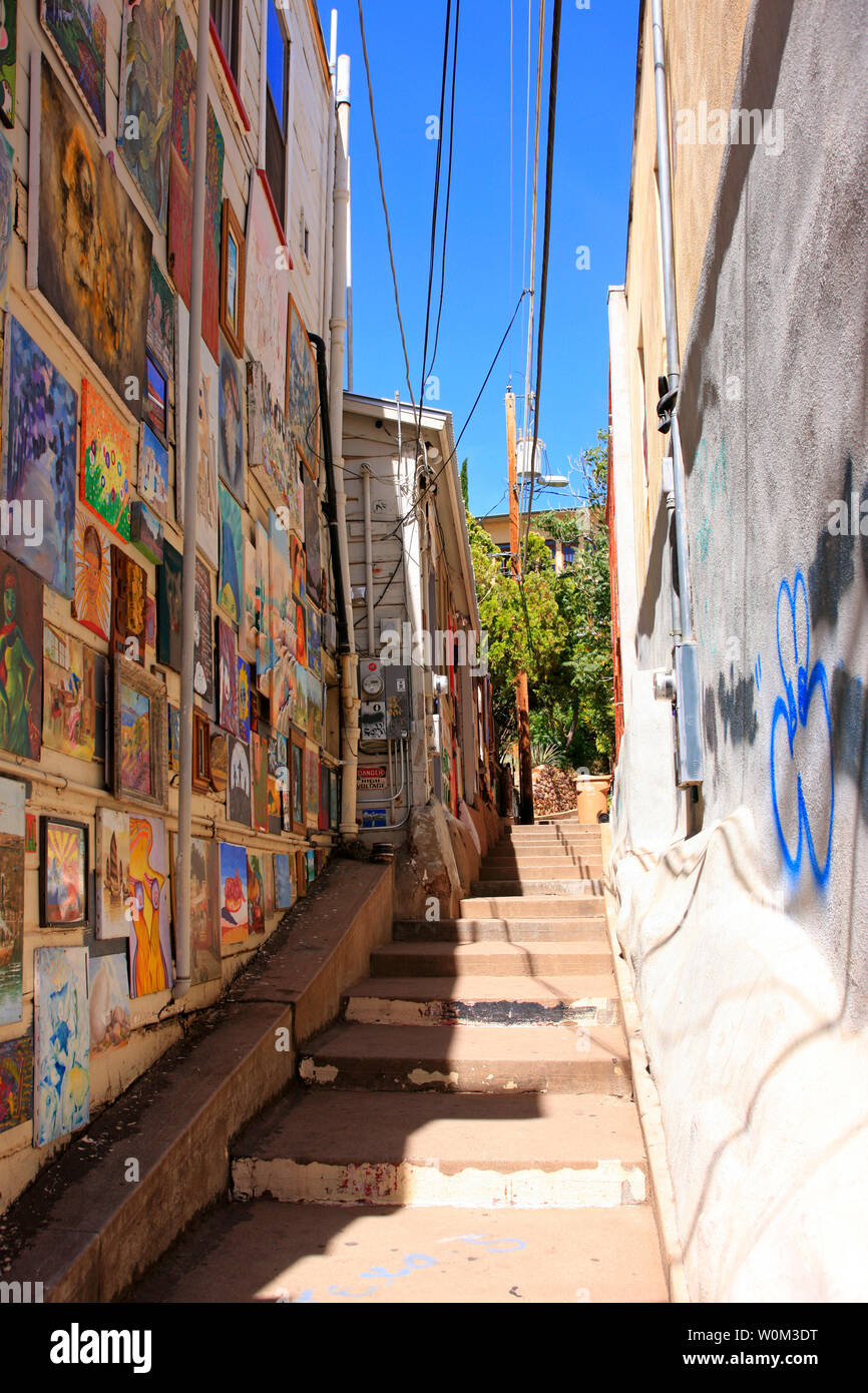 Amateur artworks placed outside on a wall of a building in an alley leading to Broadway from Brewery Ave in Bisbee, AZ Stock Photo