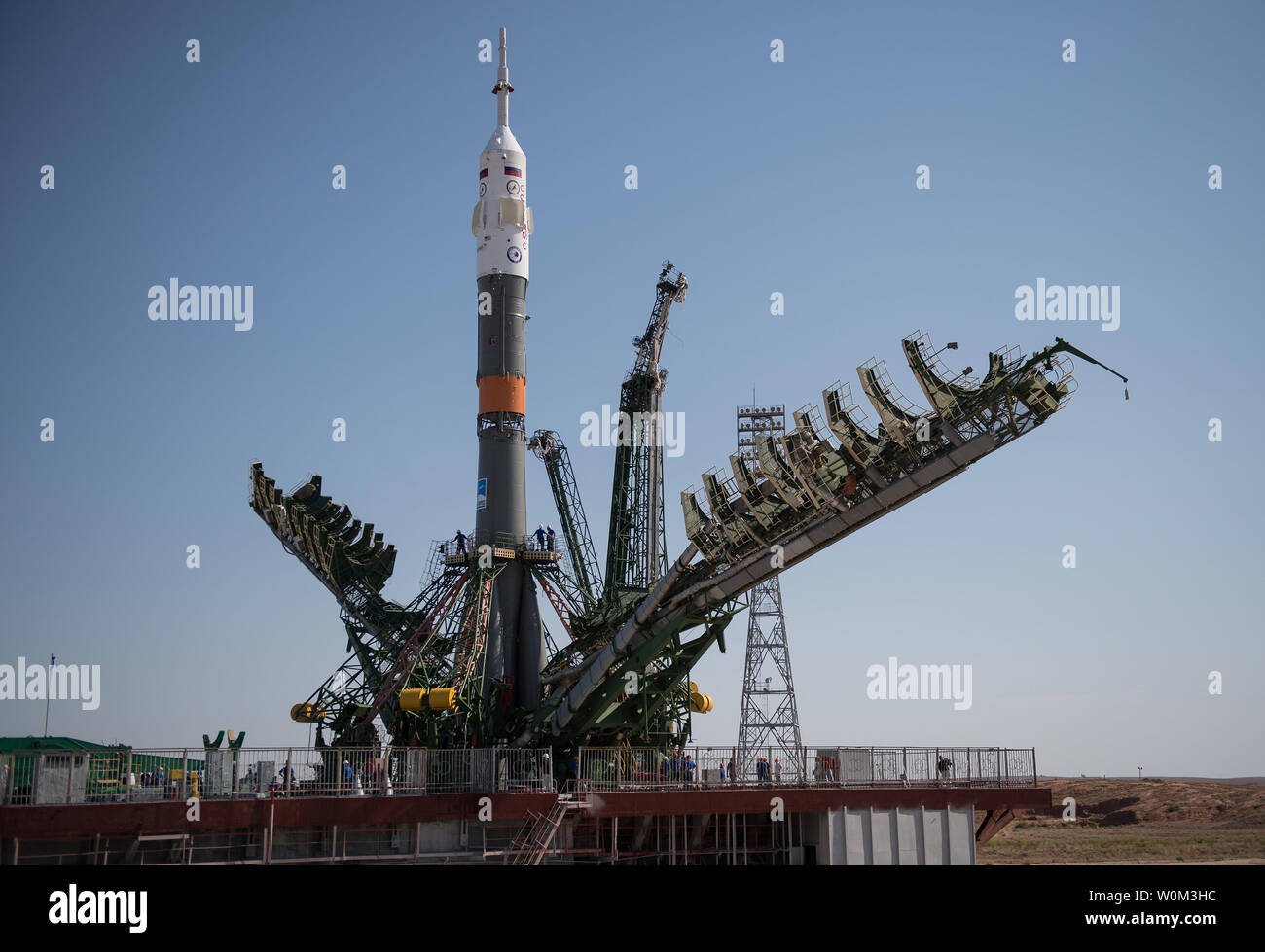 The Soyuz MS-05 spacecraft is seen as the service structure arms begin to close on the launch pad at the Baikonur Cosmodrome, Kazakhstan, on July 26, 2017. Expedition 52 flight engineer Sergei Ryazanskiy of Roscosmos, flight engineer Randy Bresnik of NASA, and flight engineer Paolo Nespoli of ESA (European Space Agency), are scheduled to launch to the International Space Station aboard the Soyuz spacecraft from the Baikonur Cosmodrome on July 28. NASA Photo by Joel Kowsky/UPI Stock Photo
