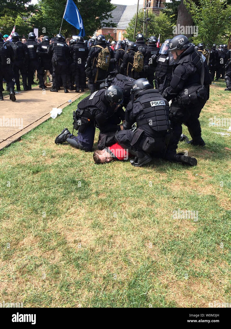 Riot police arrest a protester during after declaring the event an unlawful assembly. Virginia Gov. Terry McAuliffe declared a state of emergency as authorities, including police and members of the National Guard, blocked off sections of Charlottesville, Virginia, on August 12, 2017. The action was in response to violence between supporters of the Alt-Right Unite the Right rally and counter-protesters in and around Emancipation Park, the intended site of the rally. Photo by Virginia State Police/UPI Stock Photo