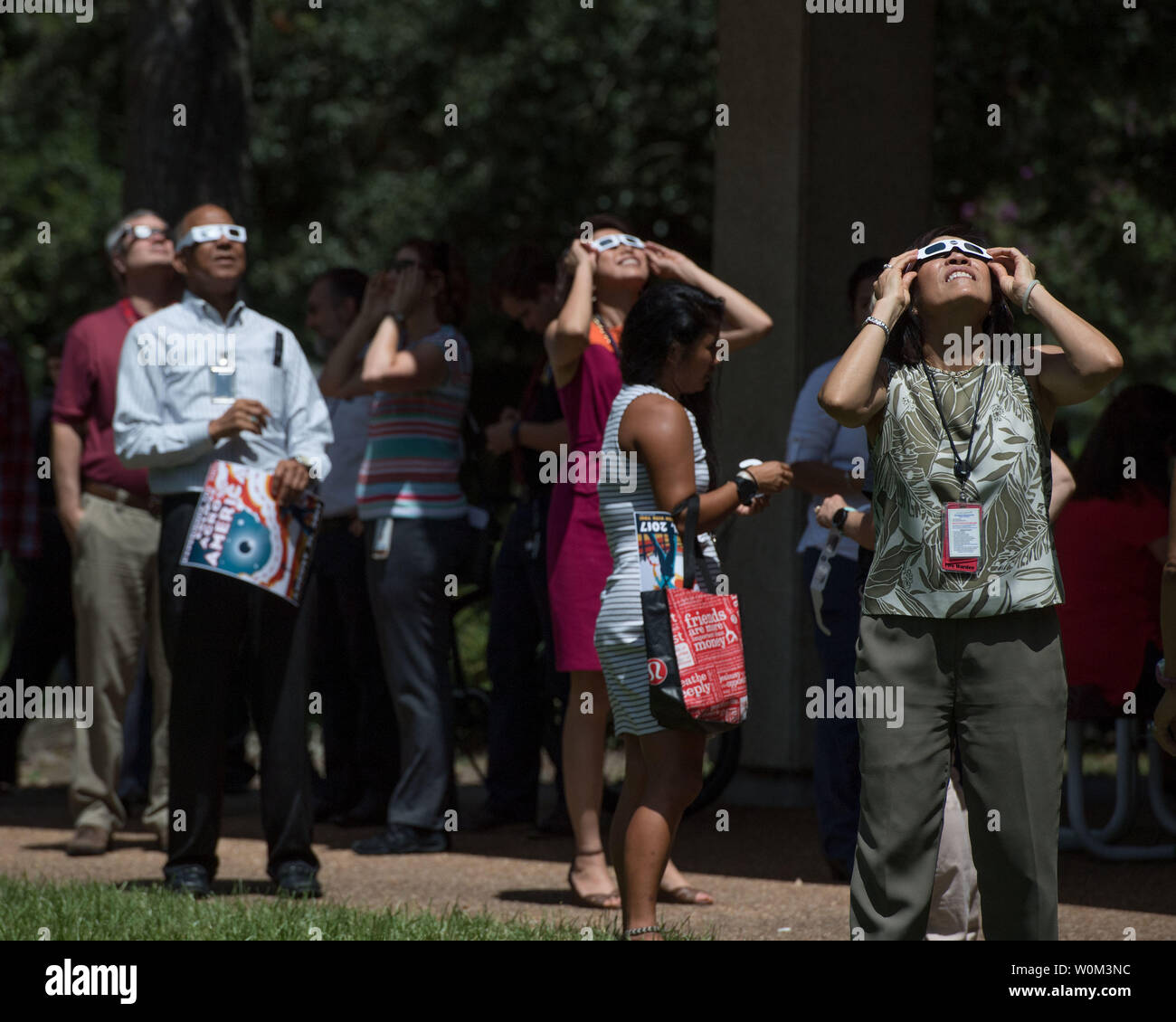 Employees at NASAÕs Johnson Space Center in Houston joined the rest of the country in experiencing the 2017 eclipse on August 21, 2017. Many used protective eclipse glasses, and others made use of manufactured or pin-hole cameras of opportunity to view the eclipse. In Houston, the partial eclipse duration was 2 hours, 59 minutes, reaching its maximum level of 67 percent at 1:17 p.m. CDT. Some members of the team supporting the International Space Station in the Christopher C. Kraft Mission Control Center took advantage of a break in their duties to step outside the windowless building to witne Stock Photo