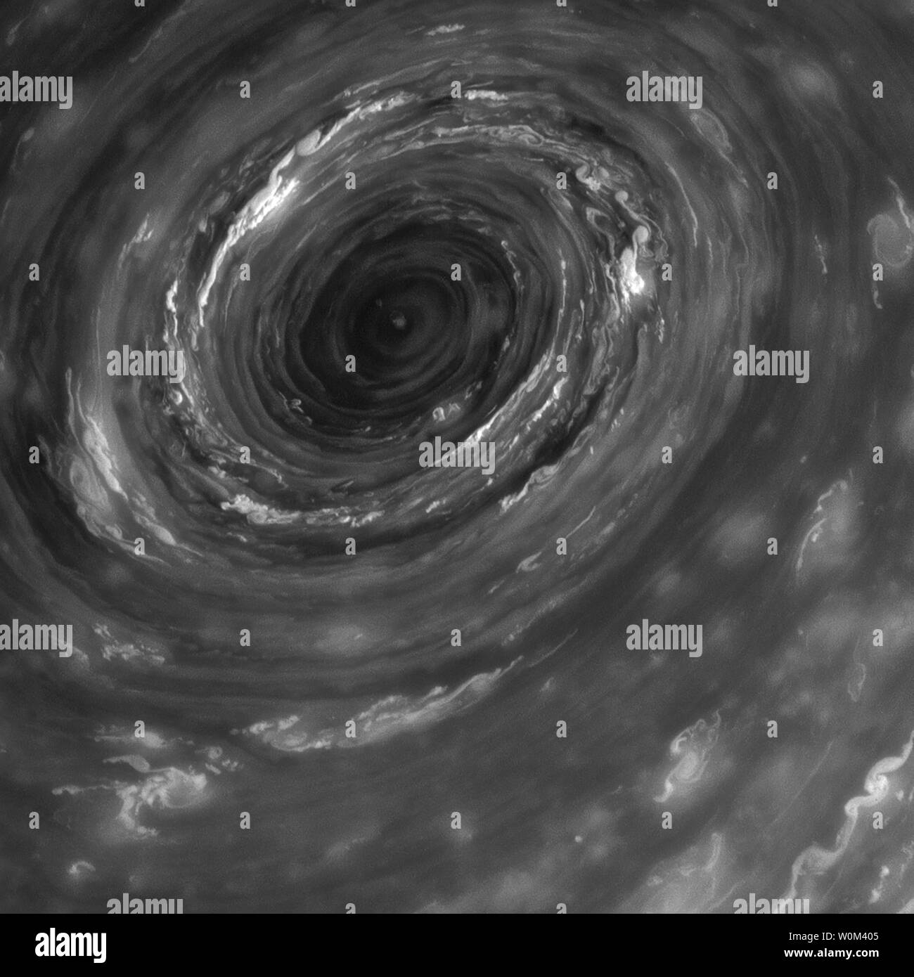 The vortex at Saturn's north pole, seen here in the infrared, is the eye of an immense cyclone, about 2,000 kilometers (1,250 miles) wide, 20 times larger than most on Earth. The image was taken with the Cassini spacecraft narrow-angle camera on June 14, 2013, using a spectral filter sensitive to wavelengths of near-infrared light centered at 750 nanometers. On September 15, 2017, after two decades in space, NASA's Cassini spacecraft made its final approach to Saturn, diving into the planet's atmosphere. Since its arrival in 2004, the Cassini-Huygens mission has been a discovery machine, revol Stock Photo