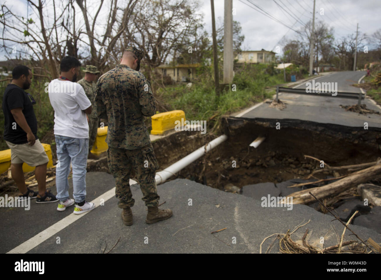 U.S. Marine Corps 1st Lt. Andrew Veal, an infantry officer with Battalion Landing Team 2nd Battalion, 6th Marine Regiment, 26th Marine Expeditionary Unit (MEU) talks to local residents regarding a damaged road caused by flooding in Ceiba, Puerto Rico, on October 2, 2017. The 26th MEU is supporting Federal Emergency Management Agency, the lead federal agency, in helping those affected by Hurricane Maria to minimize suffering and is one component of the overall whole-of-government response effort. Photo by Cpl. Juan Soto-Delgado/USMC/UPI Stock Photo