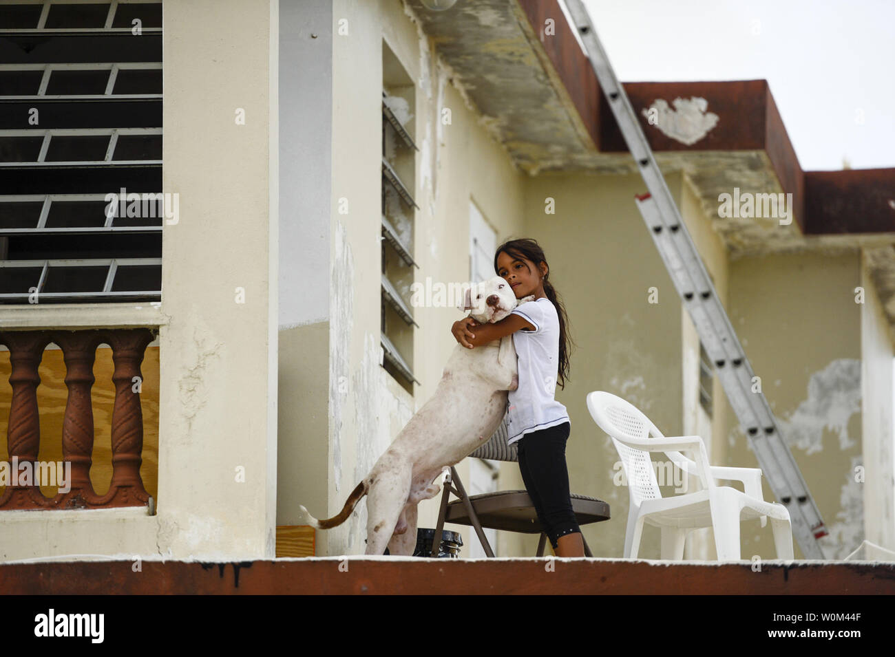 Fabiola Vazquez Barriel, 10, hugs her dog, Apollo, in San Juan, Puerto Rico, on October 3, 2017. The people of Puerto Rico are resilient, evidenced by the stories of neighbor helping neighbor, and communities helping communities after Hurricane Maria devastated the island. Photo by Master Sgt. Joshua DeMotts/U.S. Air Force/UPI Stock Photo