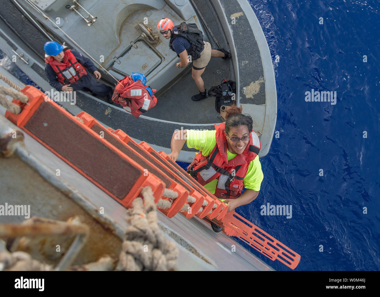 Tasha Fuiaba, an American mariner who had been sailing for five months on a damaged sailboat, climbs the accommodation ladder to board the amphibious dock landing ship USS Ashland (LSD 48) on October 25, 2017. Ashland, operating in the Indo-Asia-Pacific region on a routine deployment, rescued two American mariners who had been in distress for several months after their sailboat had a motor failure and had strayed well off its original course while traversing the Pacific Ocean. Photo by MC3 Jonathan Clay/U.S. Navy/UPI. Stock Photo