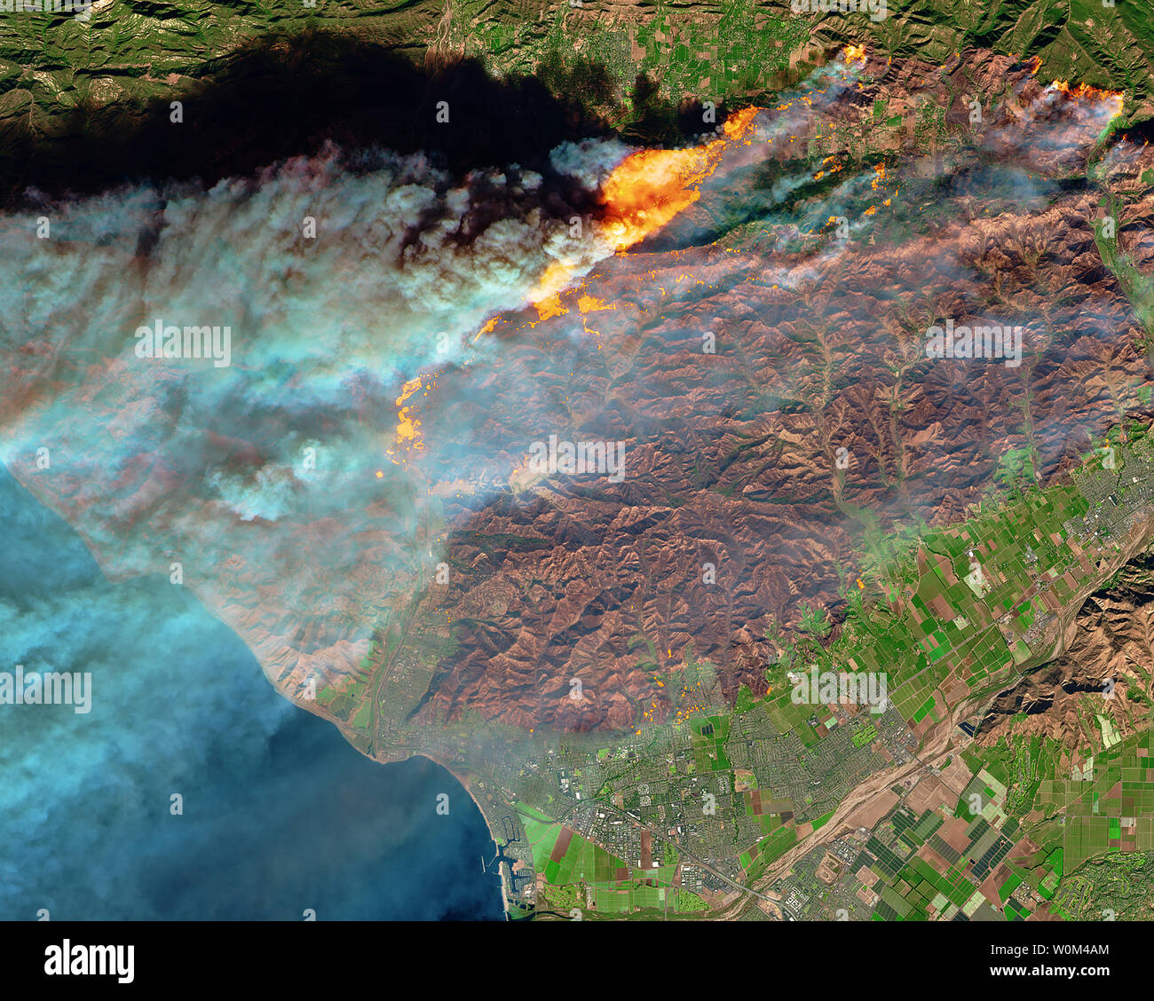 On December 5, 2017, the Multi-Spectral Imager (MSI) on the European Space Agency's Sentinel-2 satellite captured the data for a false-color image of the burn scar in Ventura County, California. Active fires appear orange; the burn scar is brown. Unburned vegetation is green; developed areas are gray. The Sentinel-2 image is based on observations of visible, shortwave infrared, and near-infrared light. The fires mainly affected a forested, hilly area north of Ventura, but flames have encroached into the northern edge of the city. On December 6, 2017, Cal Fire estimated that at least 12,000 str Stock Photo