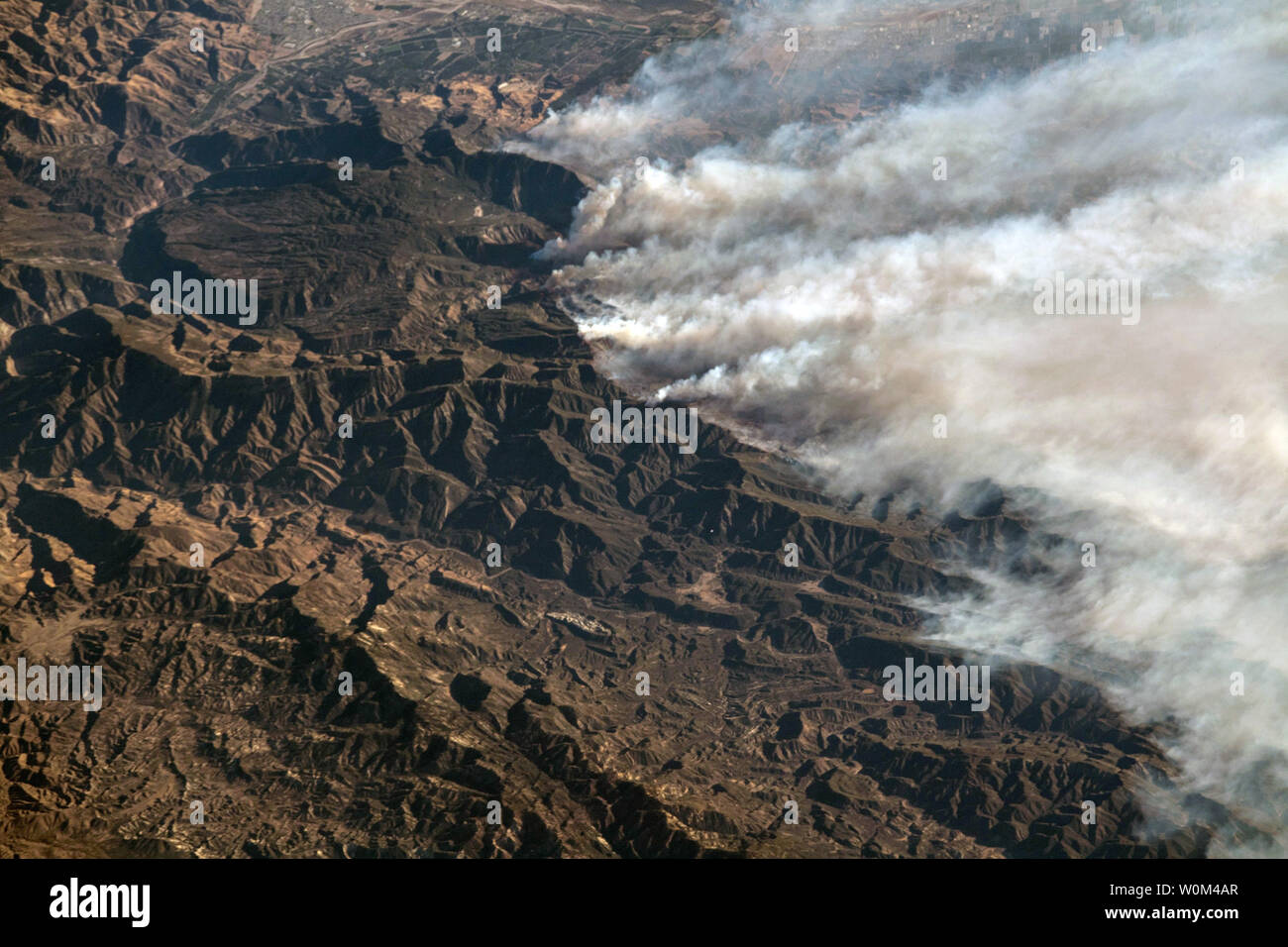 Expedition 53 Commander Randy Bresnik aboard the International Space Station took this photo of the California wildfires in the Los Angeles on December 6, 2017. This raging inferno that has been described by firefighters as a 'war zone' started just four days ago on December 4. Burning more than 96,000 acres and 150 structures to date according to Inciweb this fire has been urged on by one particular meteorological phenomenon in California, the Santa Ana (also known as the Diablo or Devil) winds. NASA/UPI Stock Photo