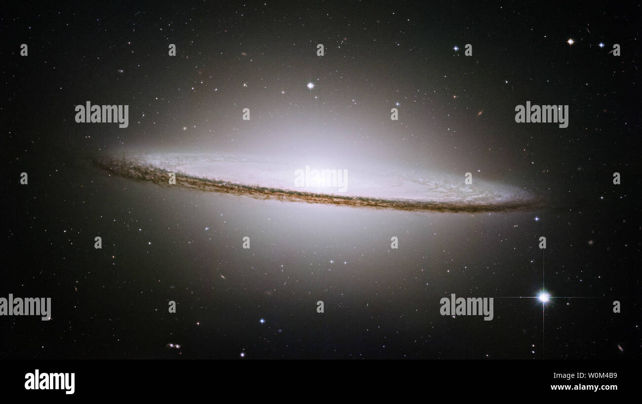 The picturesque Sombrero galaxy is shown in a composite image by Hubble's Advanced Camera for Surveys, and released October 2, 2003 by the Hubble Heritage Team of astronomers.  The Heritage team is celebrating its fifth anniversary with the release of the Sombrero galaxy.  The photo reveals a myriad of stars in a pancake-shaped disk as well as a glowing central bulge of stars.  (UPI/NASA) Stock Photo