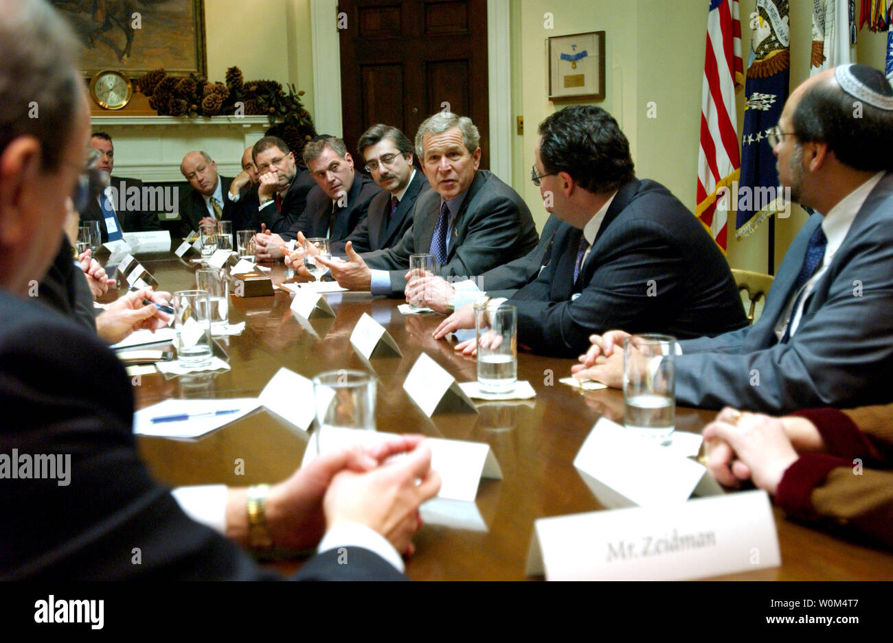 President George W. Bush meets with a group of Jewish community leaders and Rabbis in the Roosevelt Room Monday, December 22, 2003. Present at the meeting were Rabbi Dr. Elie Abadie, New York City; Rabbi Kenneth Auman, Brooklyn, New York; Matt Brooks, Washington, D.C.; Lew Eisenberg, New York City; Sam Fox, St. Louis, Mo.; Cheryl Halpern, Livingston, N.J.; Malcolm Hoenlein, New York City; Stephen Hoffman, New York City; Howard Jonas, Newark, N.J.; Joel Kaplan, Long Island, N.Y.; Rabbi David Kessel, Austin, Texas; Rabbi Moshe Kletenick, Seattle, Wash.; Howard Kohr, Washington, D.C.; Michael Leb Stock Photo