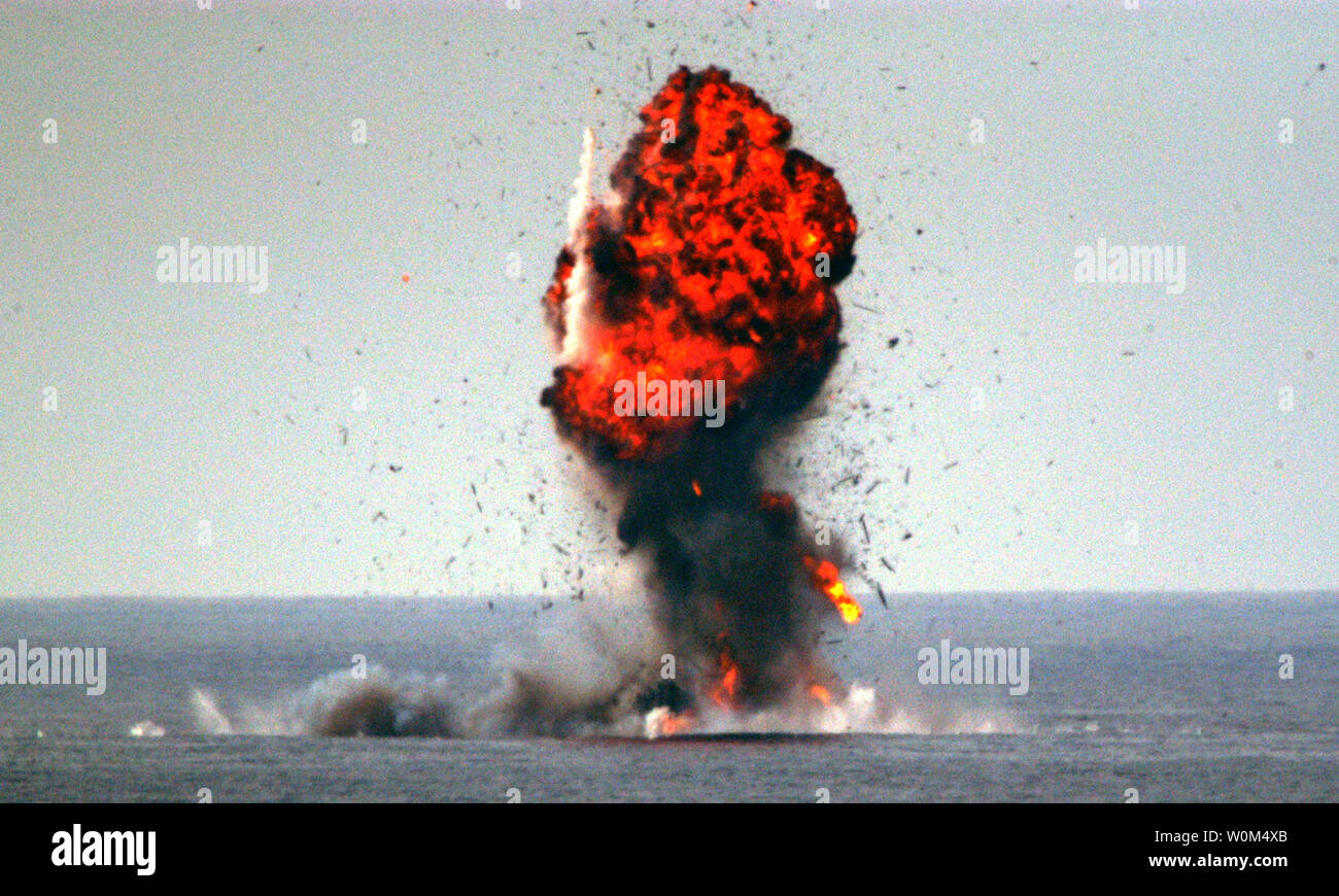 U.S. Navy and Marine Corps Explosive Ordnance Disposal (EOD) personnel destroy a captured dhow after a successful interception mission by ships from Expeditionary Strike Group One (ESG-1) on January 1, 2004 in the North Arabian Sea.  The stateless vessel's 15 crew members and 2,800 pounds of hashish, worth approximately $11 million, were intercepted and detained.  The interception was the third in two weeks by coalition maritime forces in the region.  The detainees remain with U.S. officials aboard U.S. warships in the region for further questioning.  With the exception of small amounts kept a Stock Photo