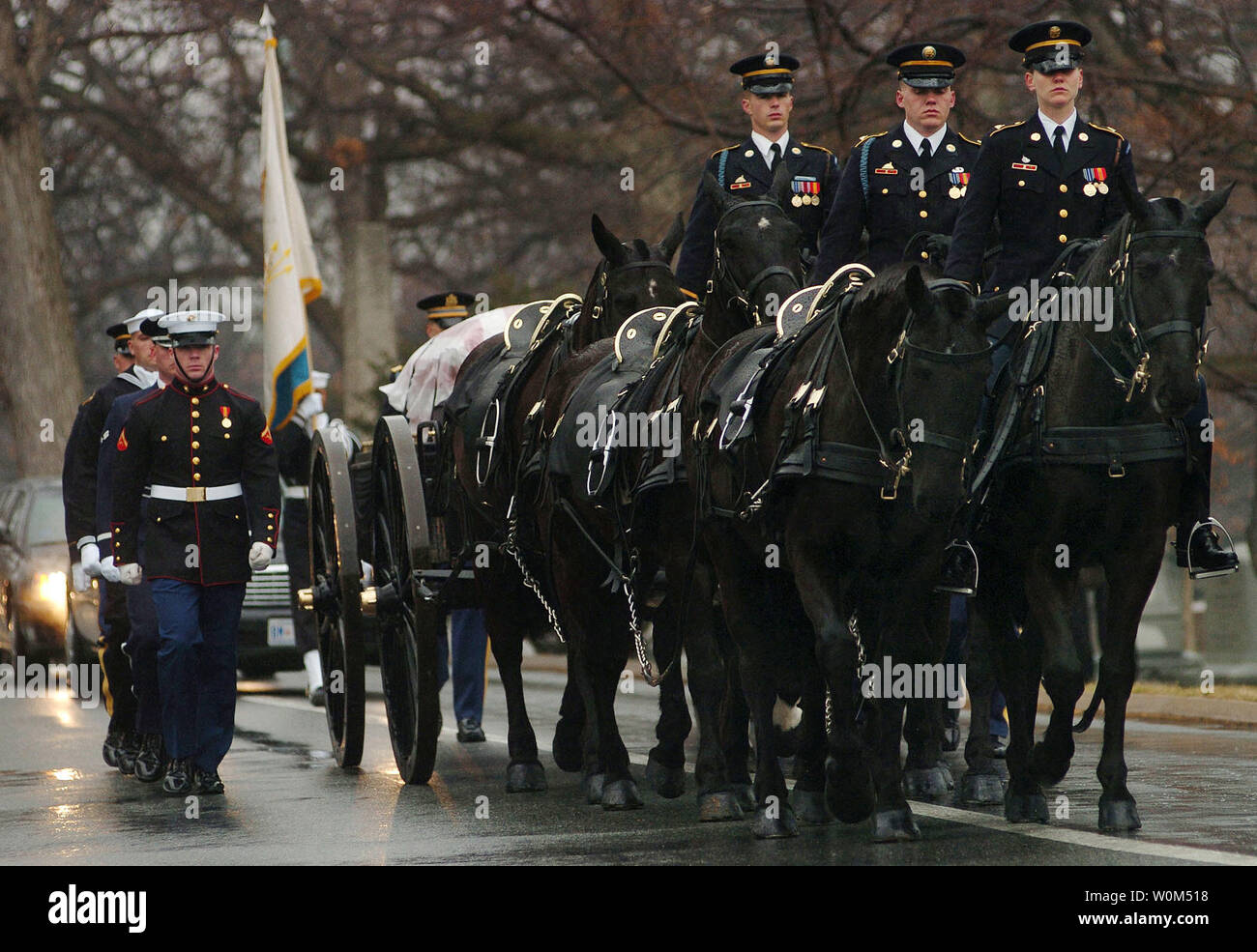 Members of the U.S. Army's 3rd Infantry 'Old Guard' caisson platoon, parade the black flag draped casket of Adm. Thomas H. Moorer, during a full military honors burial at Arlington National Cemetery on February 20, 2004. Adm. Moorer is a graduate of the Naval Academy class of1933 and went on to served as the Chief of Naval Operations from 1967-1970, whereupon he was appointed Chairman of the Joint Chiefs of Staff, a post he held until his retirement in 1974. A former naval aviator, Moorer earned many medals and honors during his career, including the Department of Defense Distinguished Service Stock Photo