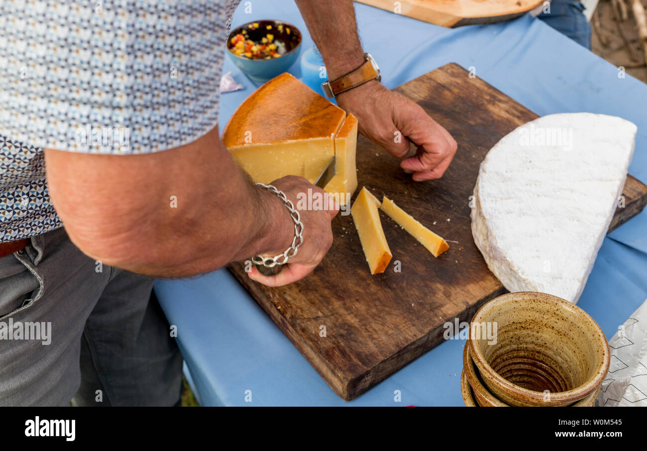 man cutting the famous dutch old cheese Stock Photo