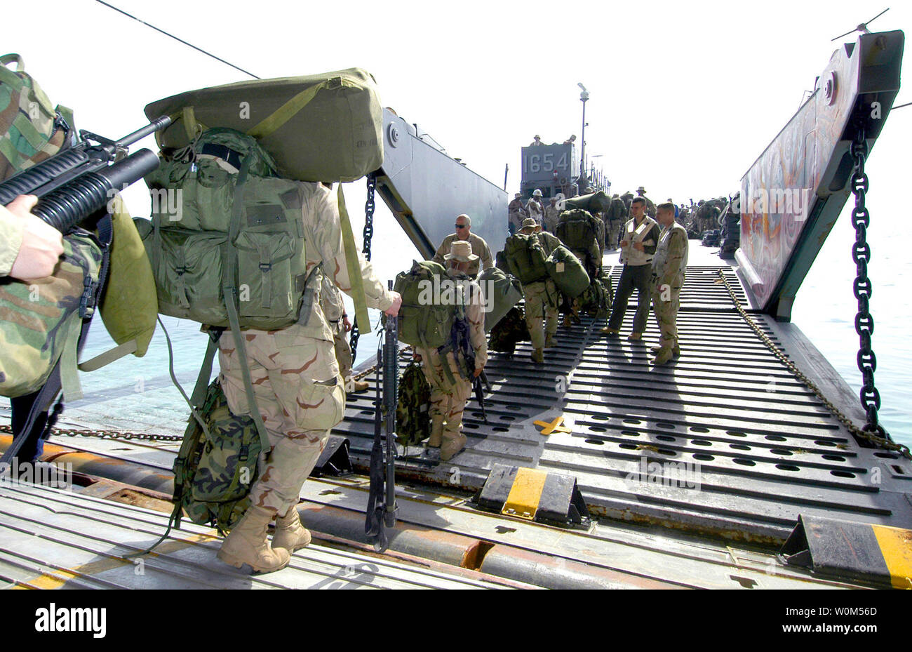 U.S. Marines assigned to 22nd Marine Expeditionary Unit (22nd MEU) Special Operations Capable (SOC) depart the amphibious assault ship USS Wasp (LHD 1) onto Landing Craft Utility 1654 (LCU 1654) in the arabian Gulf on March 28, 2004. The Landing Craft is assigned to the amphibious transport ship USS Shreveport (LPD 12). The Marines are off-loading in support of their mission in the 5th Fleet Area of Responsibility (AOR). Wasp, Shreveport and 22nd MEU (SOC) are currently on deployment as part of Expeditionary Strike Group Two (ESG 2).  (UPI Photo/Keith Simmons/U.S. Navy) Stock Photo