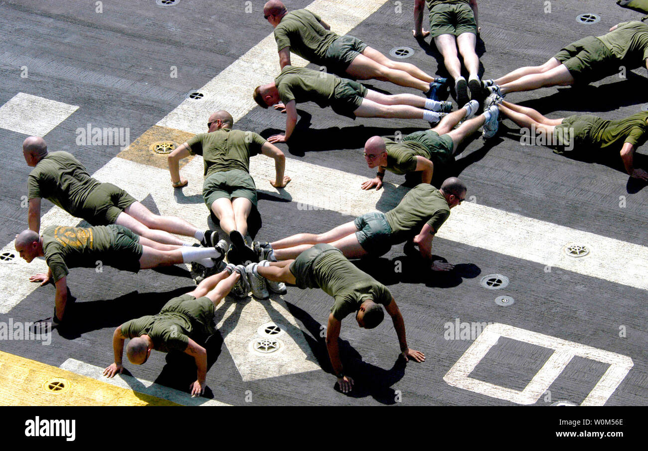 U.S. Marines assigned to 22nd Marine Expeditionary Unit (22nd MEU) Special Operations Capable (SOC) conduct physical training in the Arabian Gulf on the flight deck of the amphibious assault ship USS Wasp (LHD 1)on March 26, 2004. The Marines stay in top physical condition  as they prepare for their mission in the 5th Fleet Area of Responsibility (AOR).  Wasp and 22nd MEU (SOC) are currently on deployment as part of Expeditionary Strike Group Two (ESG 2). (UPI Photo/Teresa J. Ellison) Stock Photo