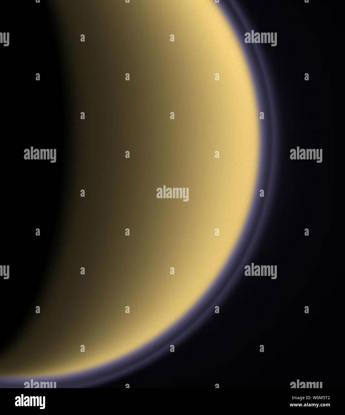 Encircled in purple stratospheric haze, Titan appears as a softly glowing sphere in this colorized image taken one day after Cassini's first flyby of that moon of Saturn on July 3, 2004.    (UPI Photo/NASA/JPL/Space Science Institute) Stock Photo