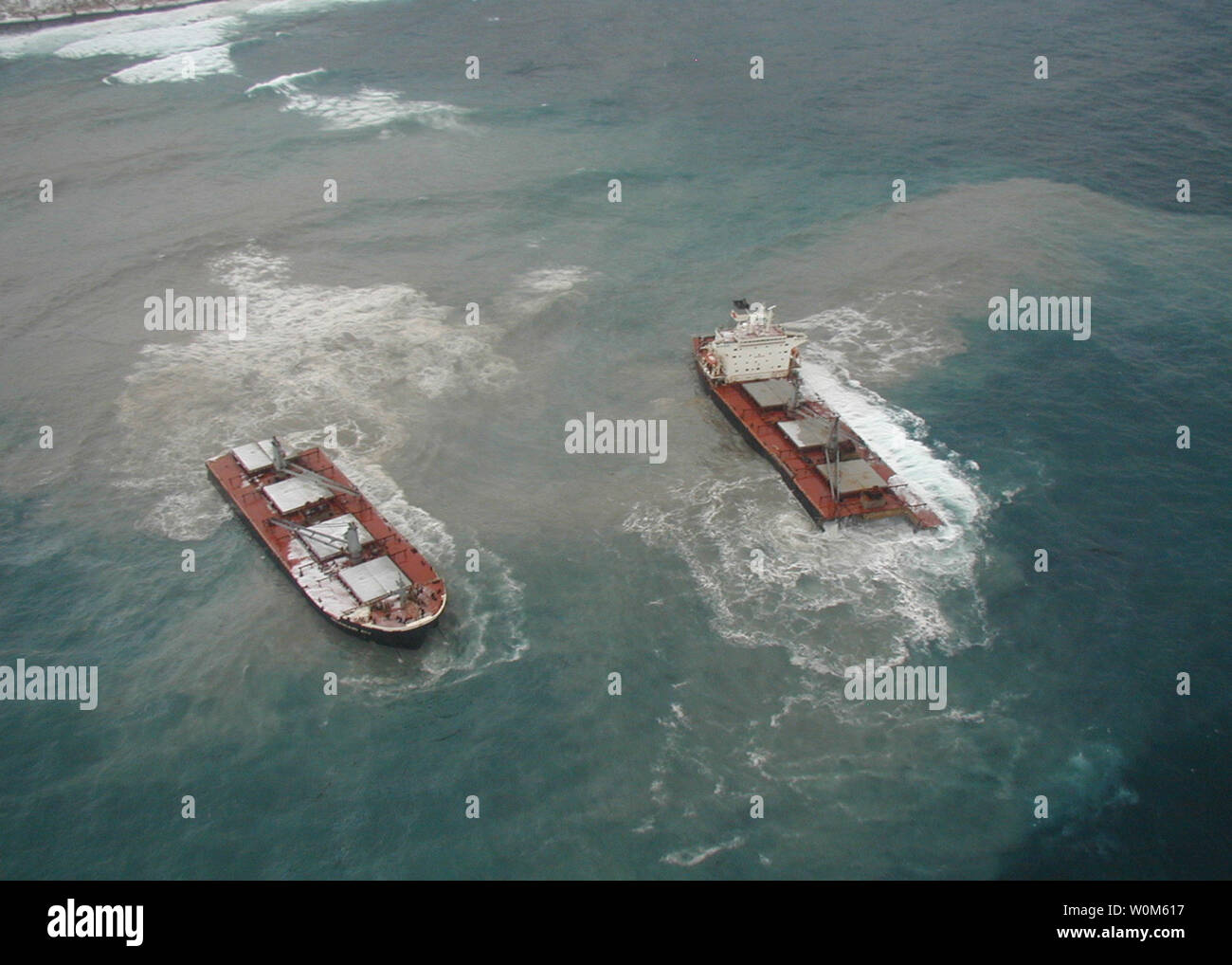 An aerial view on Dec. 9, 2004, of the Selendang Ayu during an Incident Command System overflight to search for possible spilled oil shows where the 738-foot vessel broke in two. The Malaysian owned freighter ran aground and split in half on Unalaska Island in the Aleutian chain on Dec. 8 after its engines failed. A Coast Guard helicopter crashed after rescuing the crew. A second Coast Guard helicopter rescue crew safely recovered the wrecked helicopter's crew and one man from the freighter. Six Selendang Auy crewmen remain missing.  (UPI Photo/Alaska Department of Fish and Game) Stock Photo