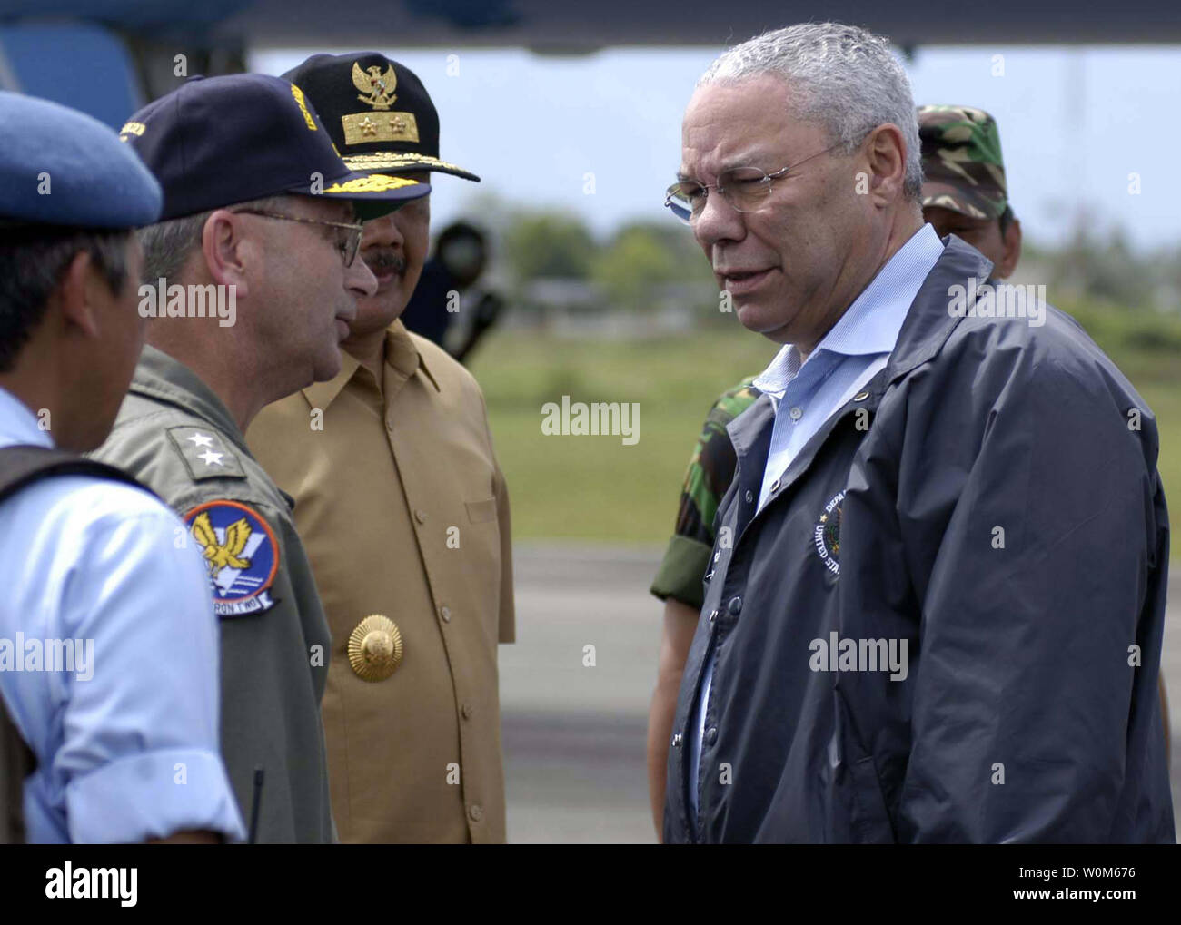 Secretary of State Colin Powell greets U.S. Navy air crewmen on the runway at Sultan Iskandar Muda Airport in Aceh, Sumatra, Indonesia on January 5, 2005.  Powell toured the area devastated by the tsunami.  (UPI Photo/Benjamin D. Glass/Navy) Stock Photo
