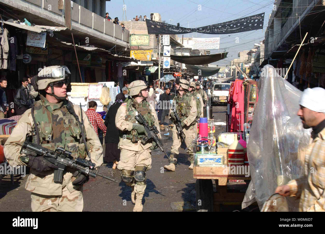 U.S. Army soldiers walk through a market in the Al Sudeek district during a dismounted patrol in Mosul, Iraq, on Jan. 9, 2005.  The soldiers are assigned to Bravo Company, 2nd Battalion, 325th Parachute Infantry Regiment, attached to Task Force Tacoma.  (UPI Photo/ Adam Sanders/Army) Stock Photo