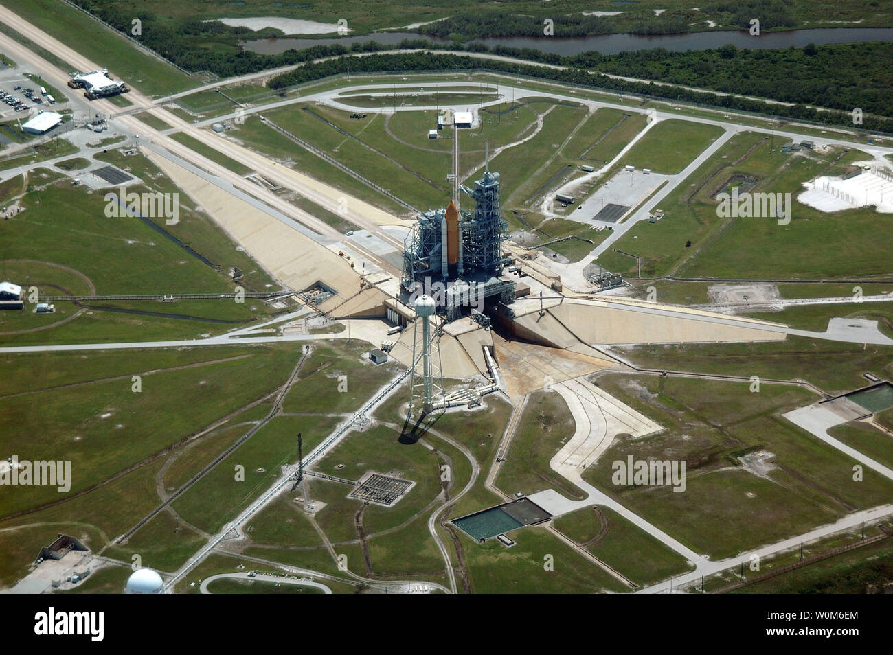 An aerial view of part of the Kennedy Space Center's giant complex featuring the Vehicle Assembly Building (VAB) and surrounding area. The Space Shuttle Discovery and its support stack of hardware, just a few days earlier, took the long, slow journey from the VAB atop the crawler/transport vehicle to Launch Pad 39B in preparation for the STS-114 mission.  NASA is planning to launch Discovery sometime in late July, when the seven-member Return to Flight crew will fly to the International Space Station primarily to test and evaluate new safety procedures. There have been many safety improvements Stock Photo
